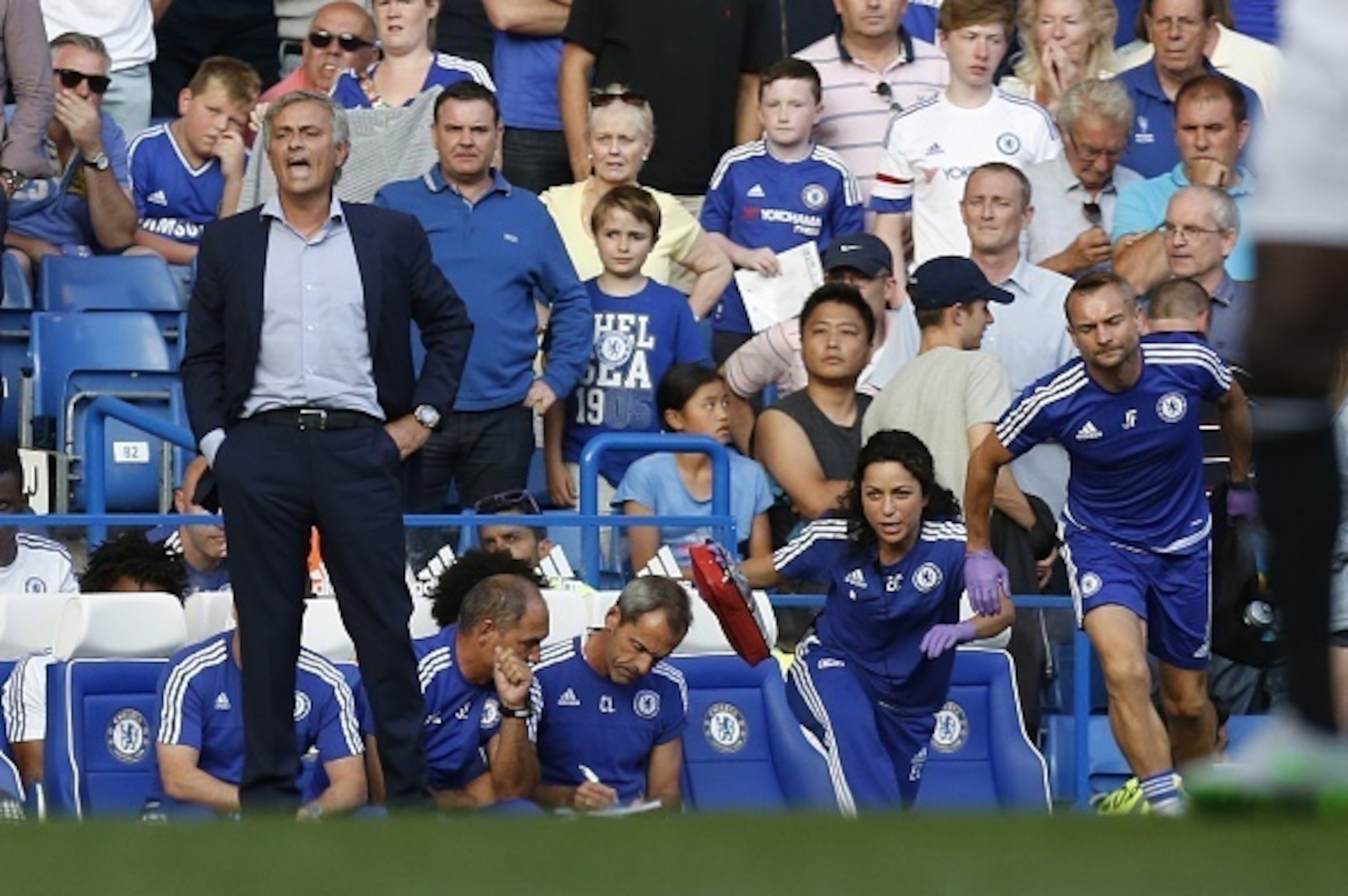 Chelsea doctor (2R) Eva Carneiro and head physio Jon Fearn (R) leave the bench to treat Chelsea's Belgian midfielder Eden Hazard late in the game as Chelsea's Portuguese manager Jose Mourinho (L) gestures during the English Premier League football match b