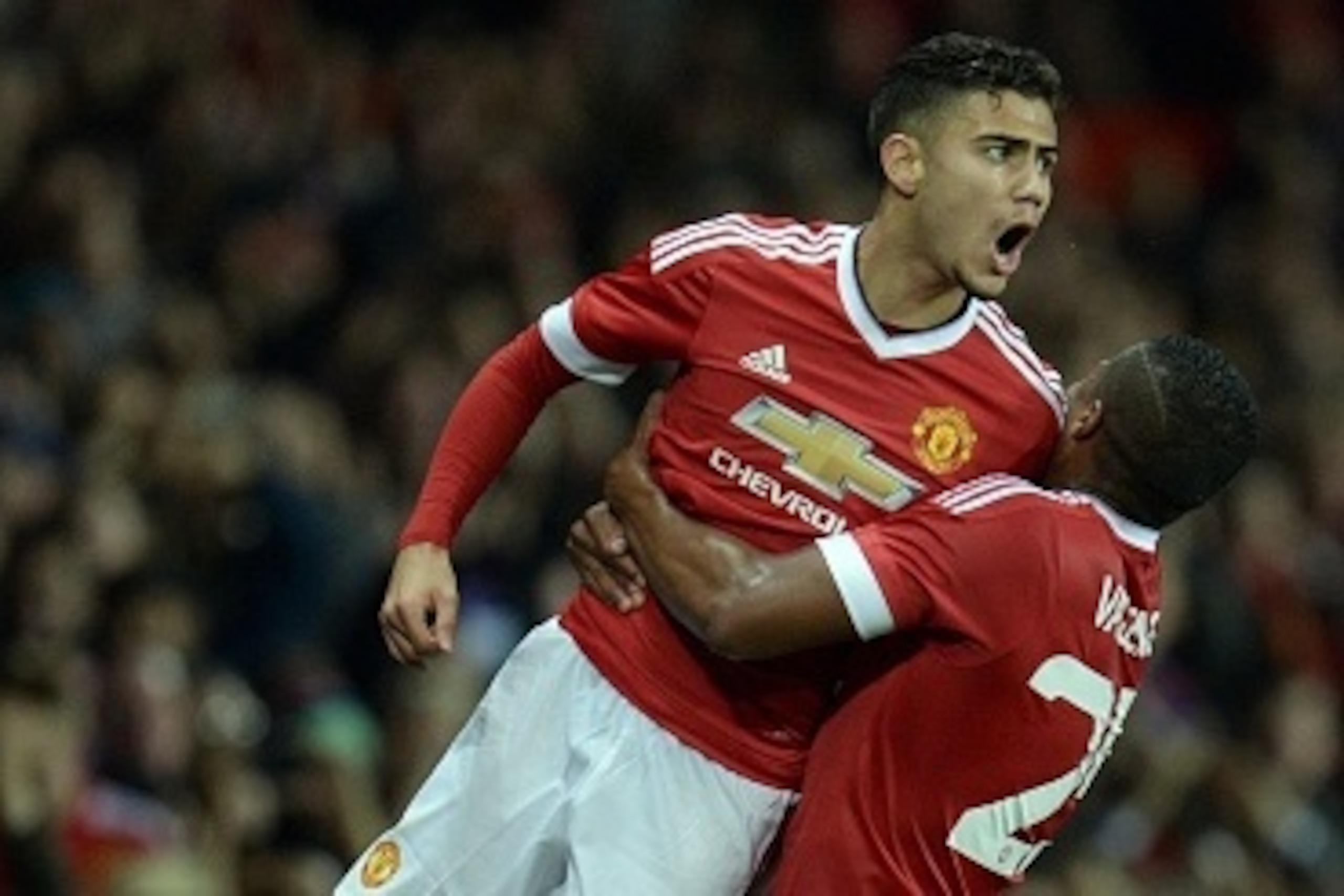 Manchester United's Belgian midfielder Andreas Pereira (L) celebrates with Manchester United's Ecuadorian midfielder Antonio Valencia after scoring their second goal from a free-kick during the English League Cup third round football match between Manches