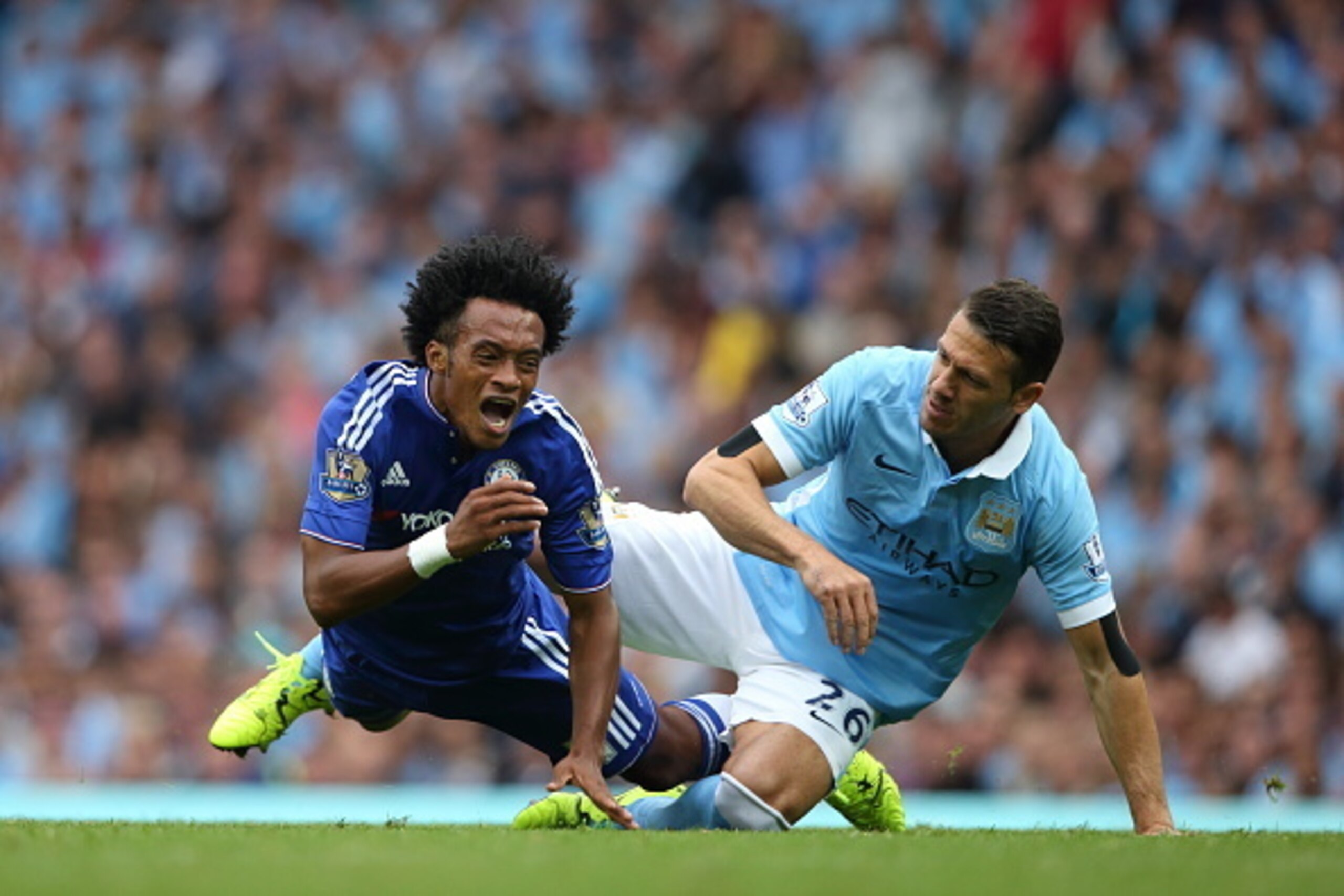 MANCHESTER, ENGLAND - AUGUST 16: Martin Demichelis of Manchester City fouls Juan Cuadrado of Chelsea during the Barclays Premier League match between Manchester City and Chelsea at the Etihad Stadium on August 16, 2015 in Manchester, England.  (Photo by M