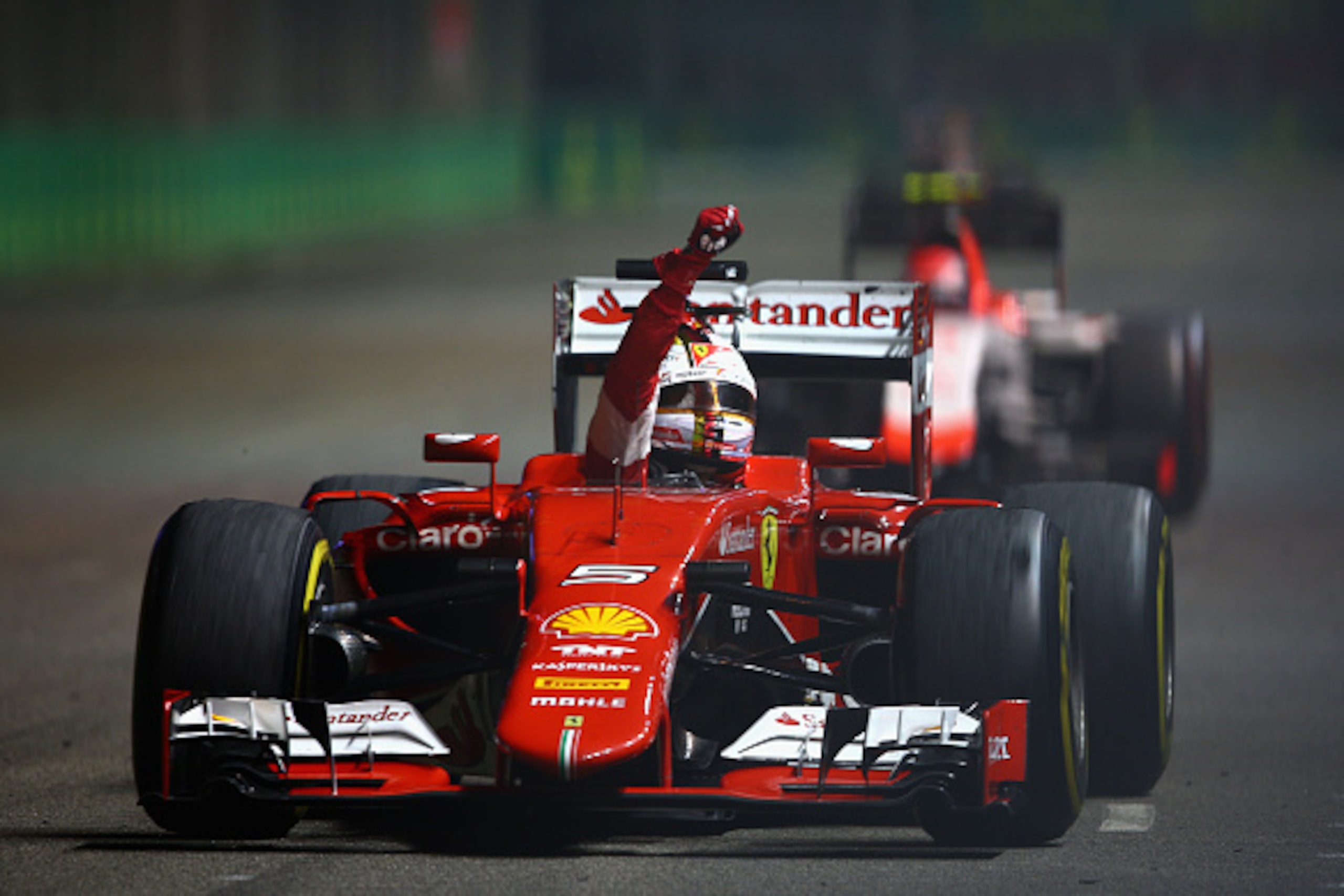 SINGAPORE - SEPTEMBER 20:  Sebastian Vettel of Germany and Ferrari celebrates in the car after winning the Formula One Grand Prix of Singapore at Marina Bay Street Circuit on September 20, 2015 in Singapore.  (Photo by Clive Mason/Getty Images)