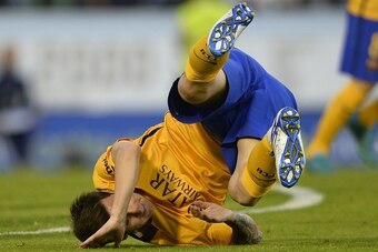 Barcelona's Argentinian forward Lionel Messi falls on the pitch  during the Spanish league football match Celta Vigo vs FC Barcelona at the Balaidos stadium in Vigo on September 23, 2015.  Celta won the match 4-1. AFP PHOTO / MIGUEL RIOPA        (Photo cr