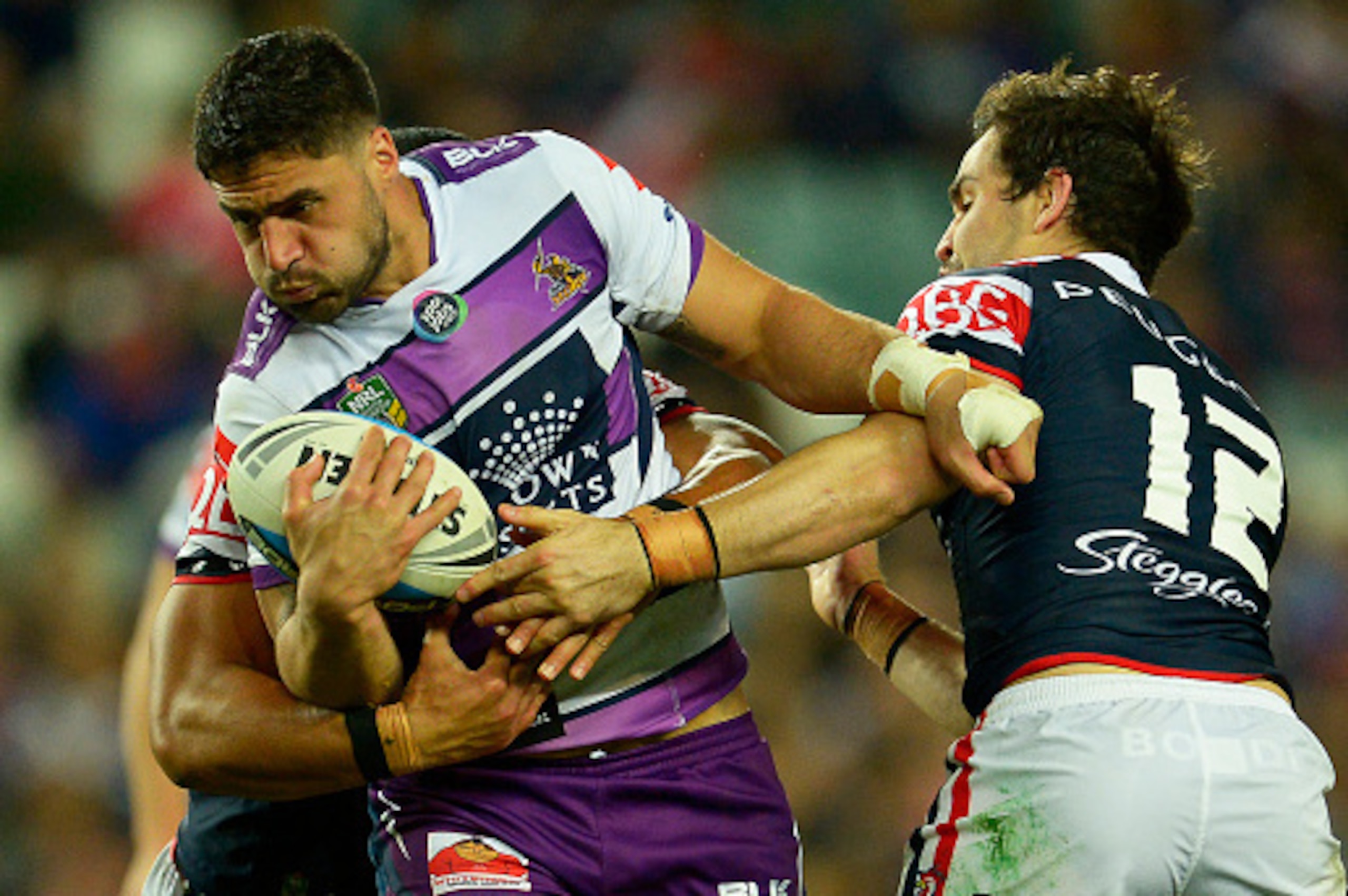SYDNEY, AUSTRALIA - SEPTEMBER 11:  Jesse Bromwich of the Storm is tackled during the NRL qualifying final match between the Sydney Roosters and the Melbourne Storm at Allianz Stadium on September 11, 2015 in Sydney, Australia.  (Photo by Brett Hemmings/Ge