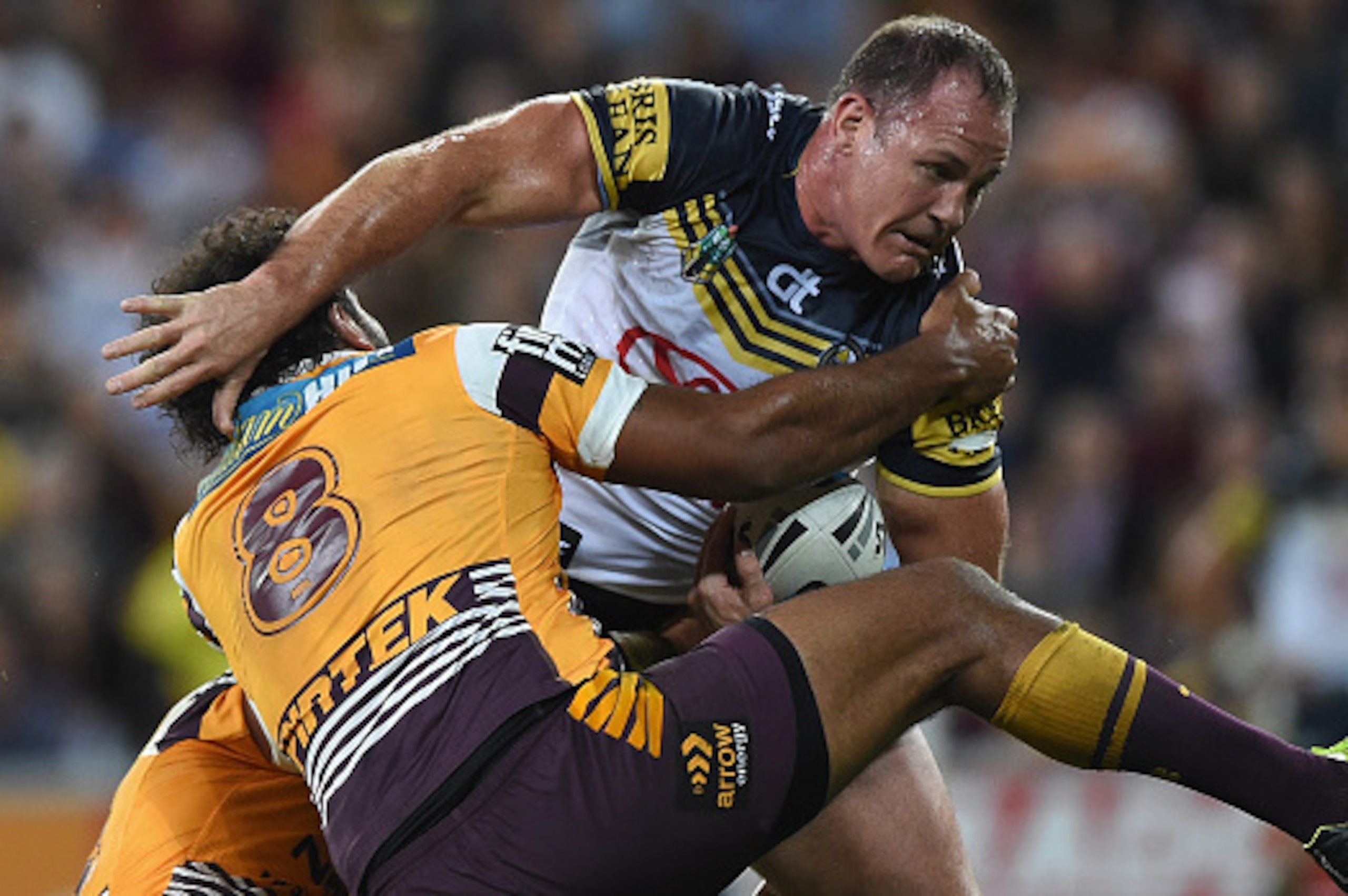 BRISBANE, AUSTRALIA - SEPTEMBER 12: Matthew Scott of the Cowboys is tackled  during the NRL Qualifying Final match between the Brisbane Broncos and the North Queensland Cowboys at Suncorp Stadium on September 12, 2015 in Brisbane, Australia.  (Photo by Ma