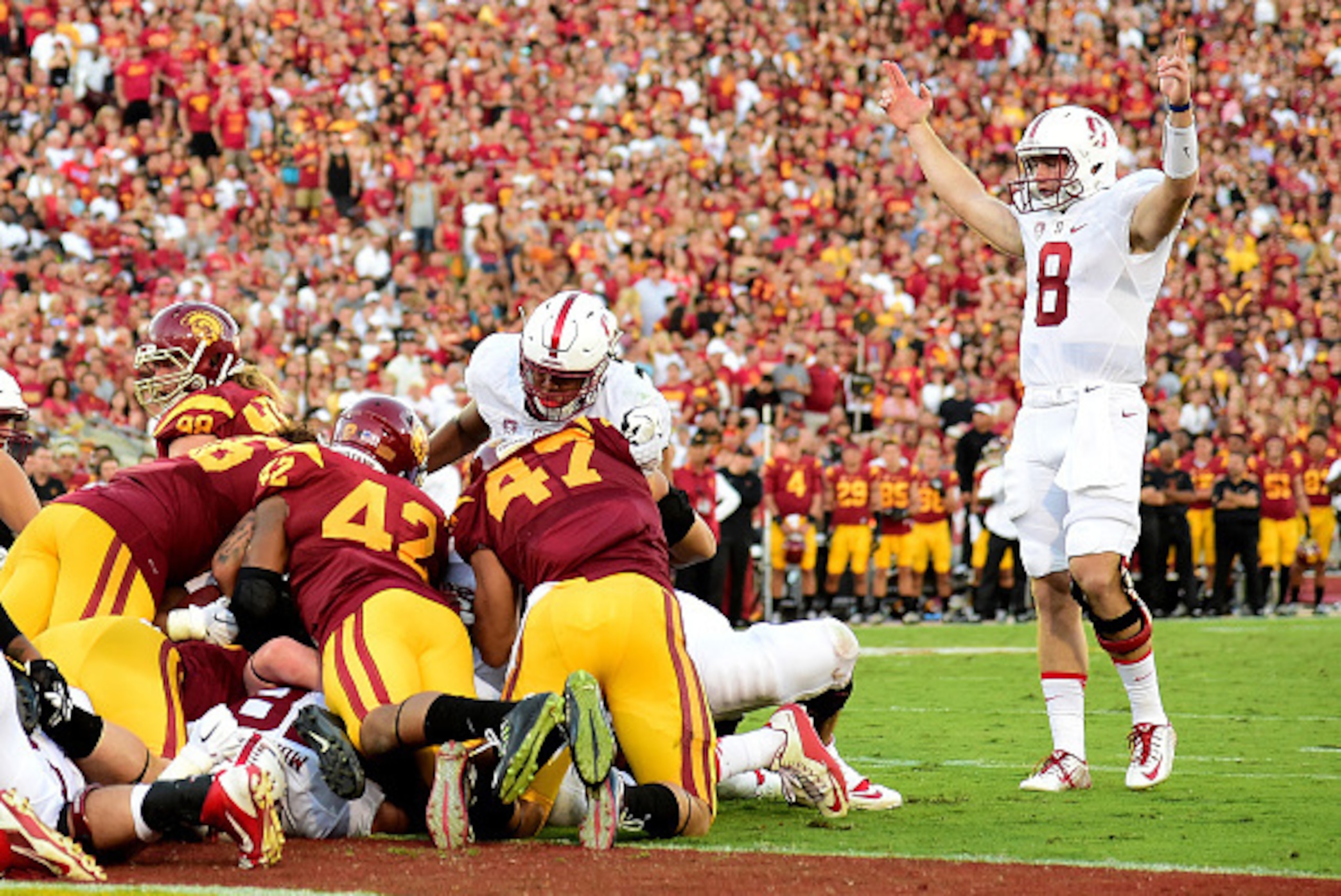 LOS ANGELES, CA - SEPTEMBER 19:  Kevin Hogan #8 of the Stanford Cardinal raises his arms in celebration of a touchdown by Remound Wright #22 at Los Angeles Coliseum on September 19, 2015 in Los Angeles, California.  The play required video review to confi