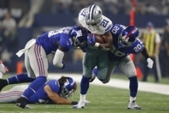 Sep 13, 2015; Arlington, TX, USA; Dallas Cowboys running back Joseph Randle (21) is tackled by New York Giants cornerback Prince Amukamara (20) and strong safety Landon Collins (21) at AT&T Stadium. Mandatory Credit: Tim Heitman-USA TODAY Sports