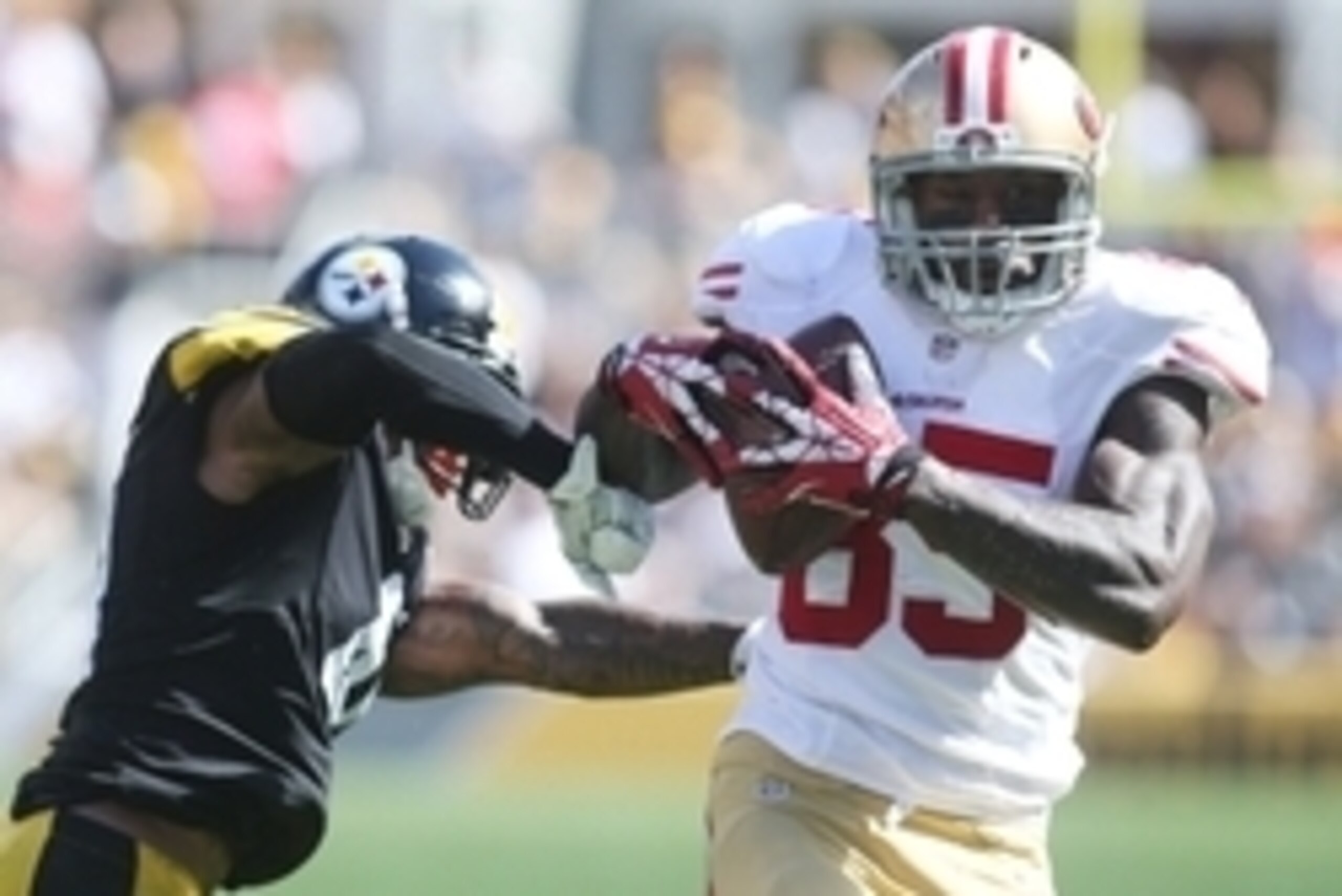 Sep 20, 2015; Pittsburgh, PA, USA; San Francisco 49ers tight end Vernon Davis (85) carries the ball as Pittsburgh Steelers cornerback Antwon Blake (L) defends during the third quarter at Heinz Field. The Steelers won 43-18. Mandatory Credit: Charles LeCla
