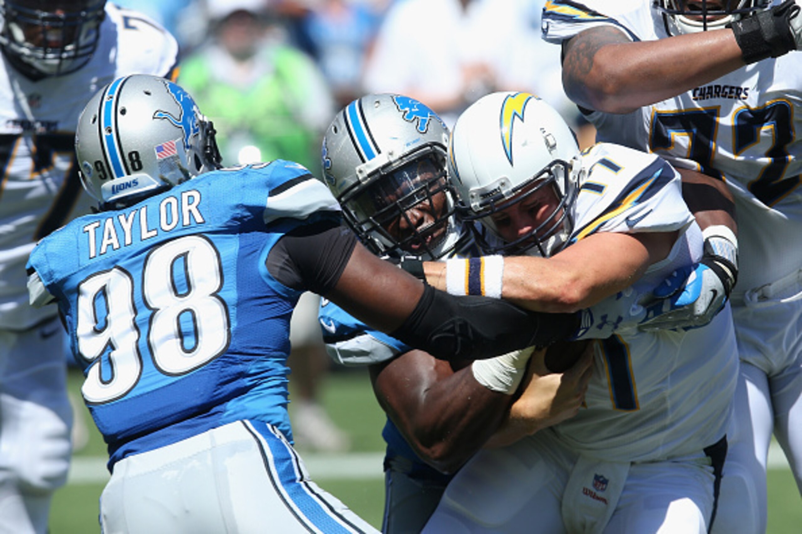 SAN DIEGO, CA - SEPTEMBER 13:  Quarterback Philip Rivers #17 of the San Diego Chargers is sacked by defensive end Ezekiel Ansah #94 and defensive end Devin Taylor #98 of the Detroit Lions at Qualcomm Stadium on September 13, 2015 in San Diego, California.