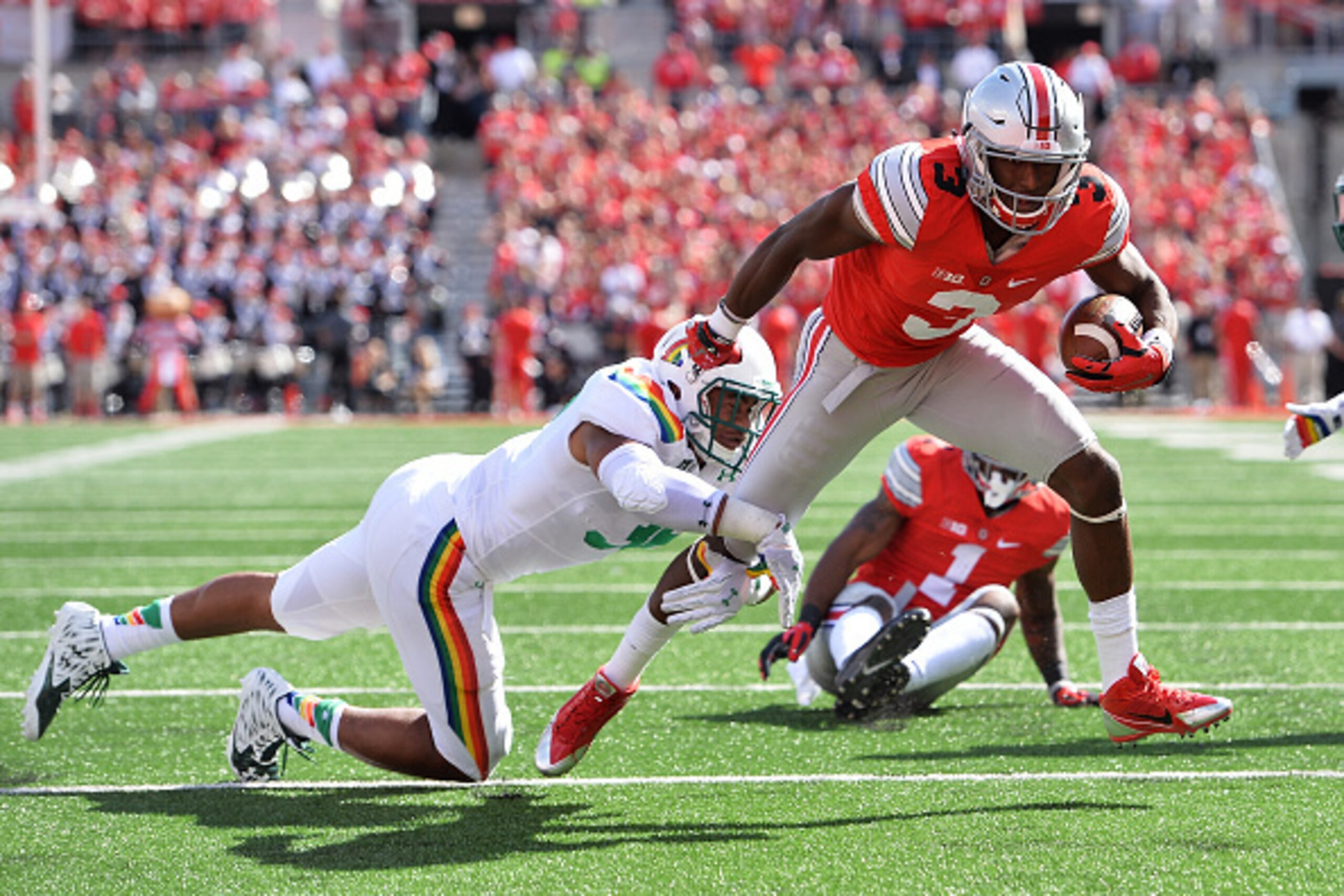 COLUMBUS, OH - SEPTEMBER 12:  Michael Thomas #3 of the Ohio State Buckeyes attempts to elude a tackle from Benetton Fonua #36 of the Hawaii Rainbow Warriors in the first quarter at Ohio Stadium on September 12, 2015 in Columbus, Ohio.  (Photo by Jamie Sab