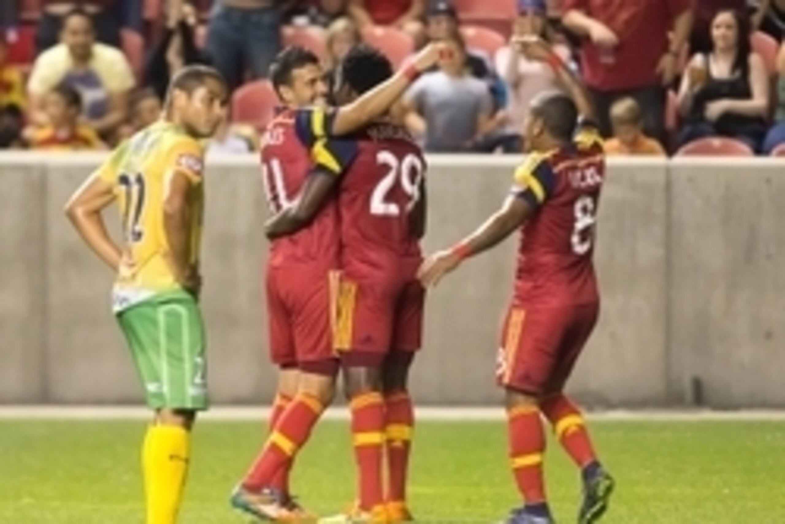 Sep 24, 2015; Sandy, UT, USA; Santa Tecla FC forward Ricardo Ferreira (22) reacts as Real Salt Lake midfielder Javier Morales (11) and defender Abdoulie Mansally (29) and forward Joao Plata (8) celebrate a goal by midfielder Juan Martinez (not pictured) d Sep 24, 2015; Sandy, UT, USA; Santa Tecla FC forward Ricardo Ferreira (22) reacts as Real Salt Lake midfielder Javier Morales (11) and defender Abdoulie Mansally (29) and forward Joao Plata (8) celebrate a goal by midfielder Juan Martinez (not pictured) d