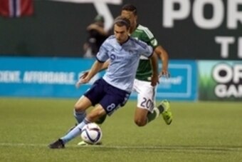 Sep 9, 2015; Portland, OR, USA; Sporting KC midfielder Graham Zusi (8) dribbles around Portland Timbers defender Taylor Peay (20) at Providence Park. Mandatory Credit: Jaime Valdez-USA TODAY Sports Sep 9, 2015; Portland, OR, USA; Sporting KC midfielder Graham Zusi (8) dribbles around Portland Timbers defender Taylor Peay (20) at Providence Park. Mandatory Credit: Jaime Valdez-USA TODAY Sports