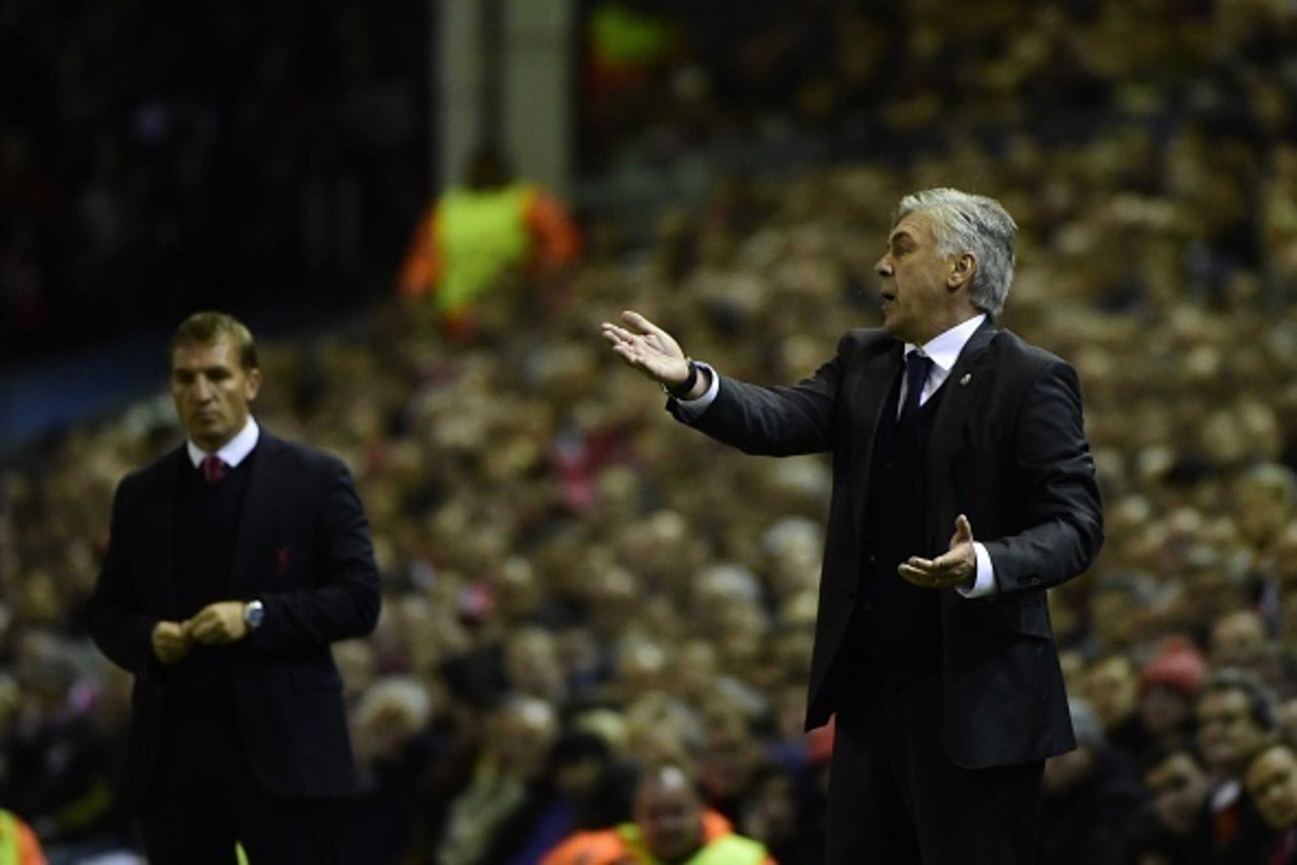 Real Madrid's Italian coach Carlo Ancelotti (R) gestures from the touchline next to Liverpool's Northern Irish manager Brendan Rodgers (L) during the UEFA Champions League, group B, football match between Liverpool and Real Madrid at Anfield in Liverpool,