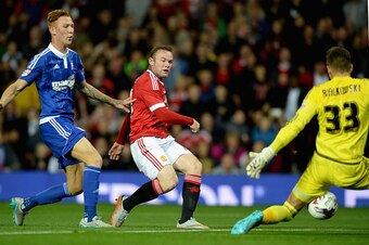MANCHESTER, ENGLAND - SEPTEMBER 23:  Wayne Rooney of Manchester United scores the opening goal past Bartosz Bialkowski of Ipswich Town during the Capital One Cup Third Round match between Manchester United and Ipswich Town at Old Trafford on September 23,