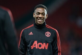Manchester United's French midfielder Anthony Martial smiles as he warms up ahead of the English League Cup third round football match between Manchester United and Ipswich Town at Old Trafford in Manchester, north west England on September 23, 2015. AFP 