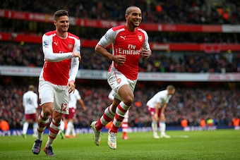 LONDON, ENGLAND - FEBRUARY 01:  Theo Walcott (R) of Arsenal is congratulated by teammate Olivier Giroud of Arsenal after scoring his team's third goal during the Barclays Premier League match between Arsenal and Aston Villa at the Emirates Stadium on Febr