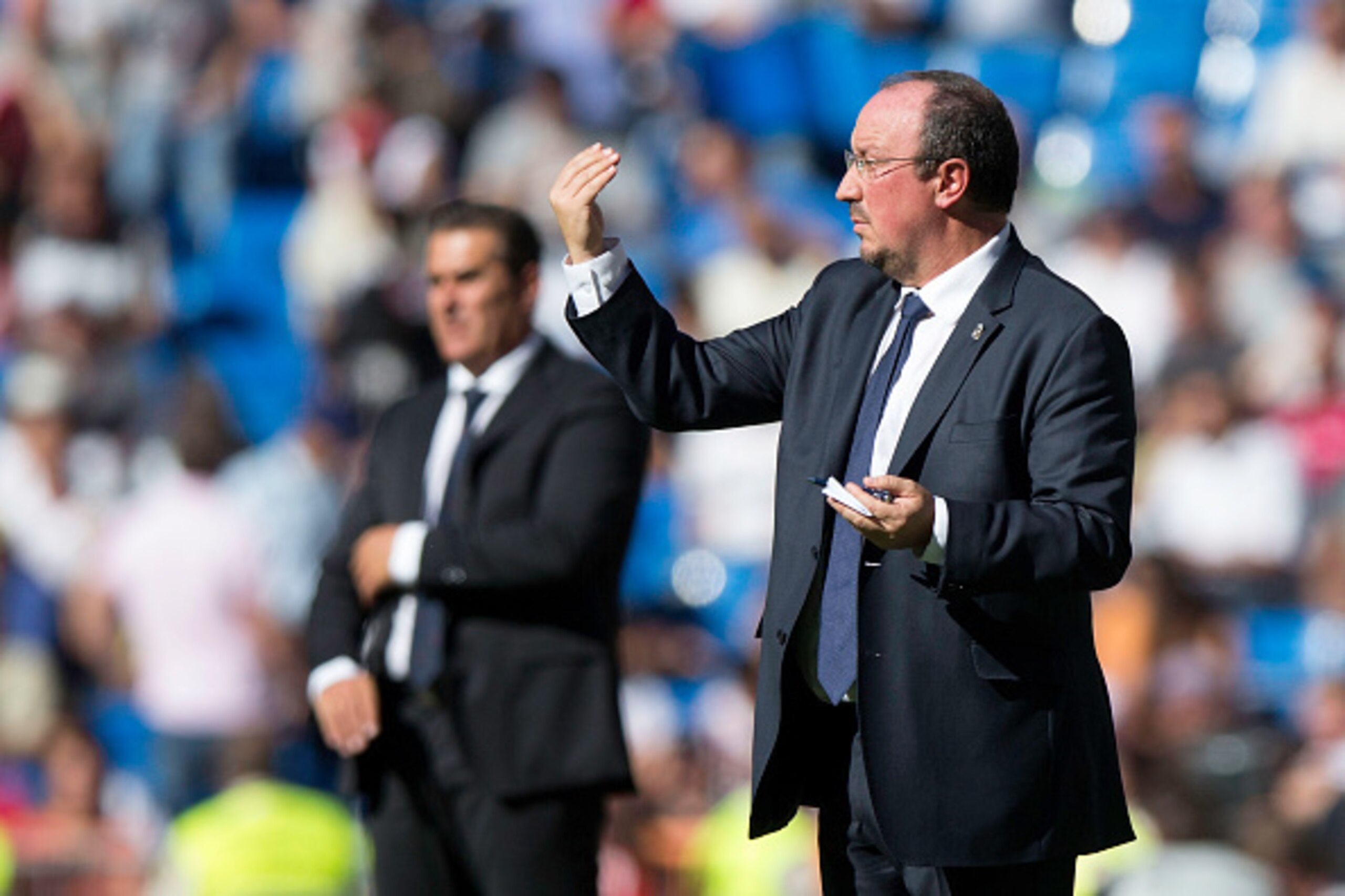 MADRID, SPAIN - SEPTEMBER 19: Head coach Rafael Benitez (R) of Real Madrid CF gives instructions ahead head coach Jose Ramon Sandoval le of Granada CF during the La Liga match between Real Madrid CF and Granada CF at Estadio Santiago Bernabeu on September