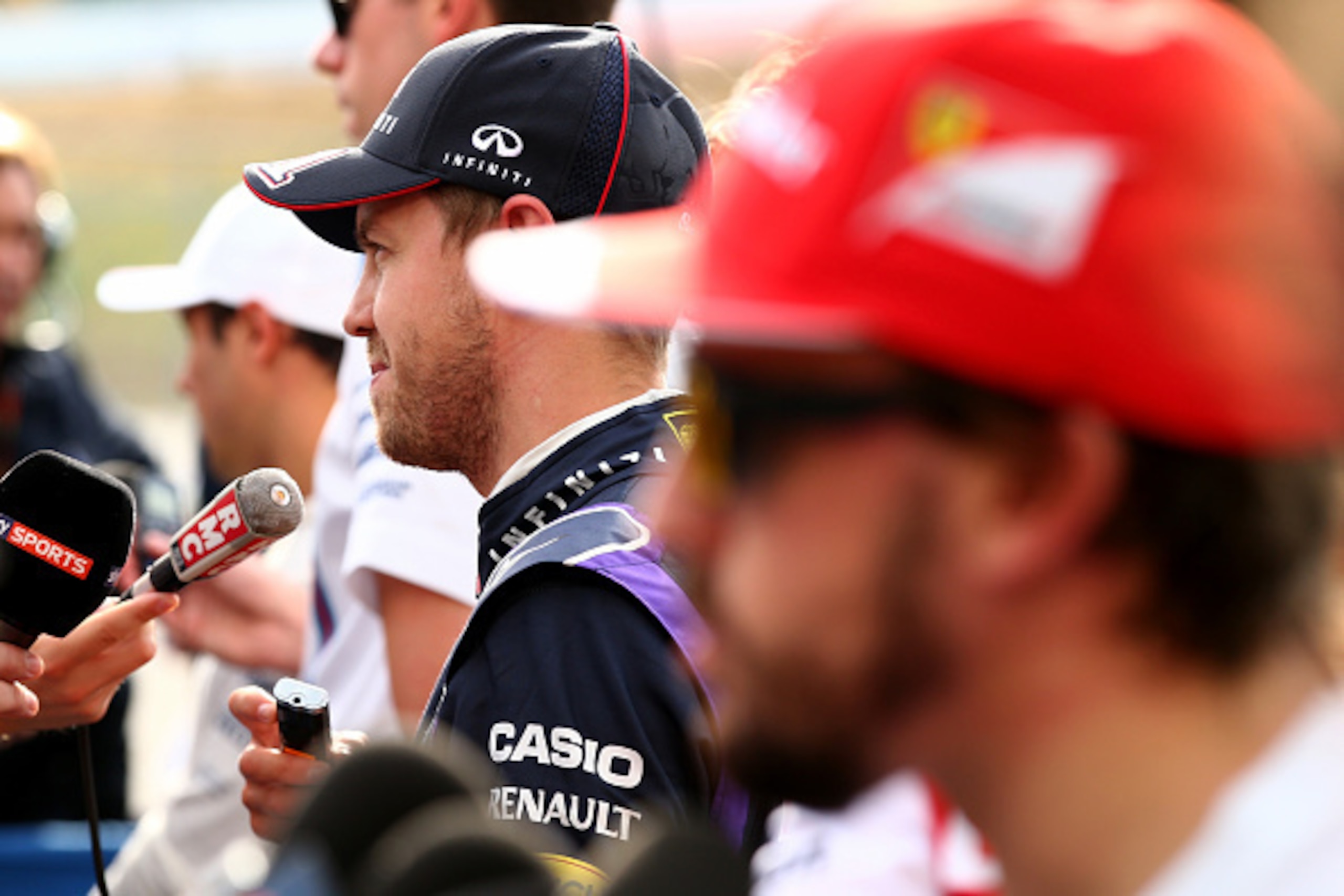 SUZUKA, JAPAN - OCTOBER 04:  Sebastian Vettel of Germany and Infiniti Red Bull Racing and Fernando Alonso of Spain and Ferrari speak to the media during Qualifying for the Japanese Formula One Grand Prix at Suzuka Circuit on October 4, 2014 in Suzuka, Jap