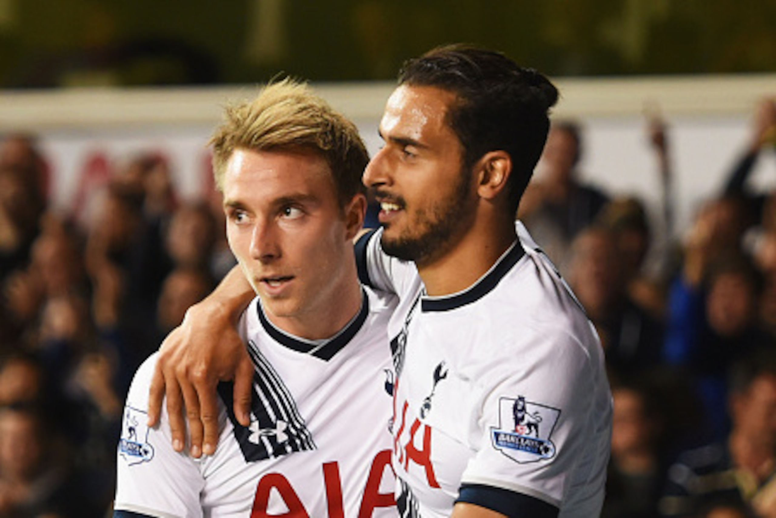 LONDON, ENGLAND - SEPTEMBER 23:  Nacer Chadli of Tottenham Hotspur (R) celebrates with Christian Eriksen as Calum Chambers of Arsenal scores an own goal for their first goal during the Capital One Cup third round match between Tottenham Hotspur and Arsena