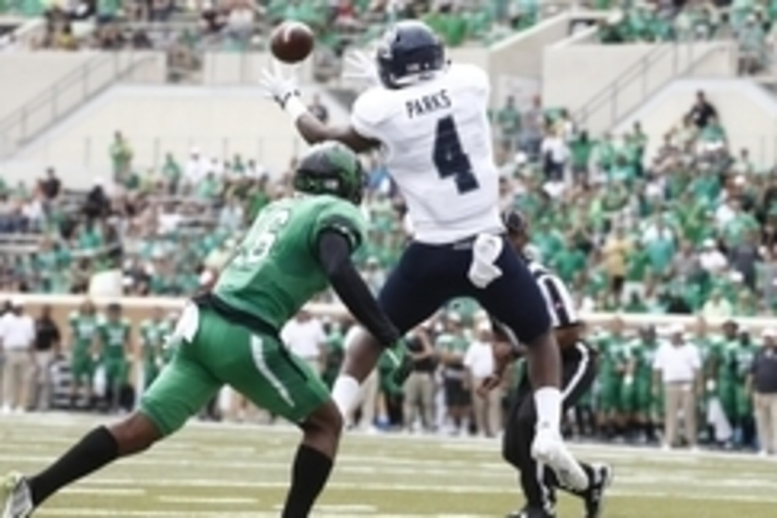 Sep 19, 2015; Denton, TX, USA; Rice Owls wide receiver Dennis Parks (4) catches a touchdown pass against North Texas Mean Green defensive back Chad Davis (16) in the second quarter  at Apogee Stadium. Mandatory Credit: Tim Heitman-USA TODAY Sports