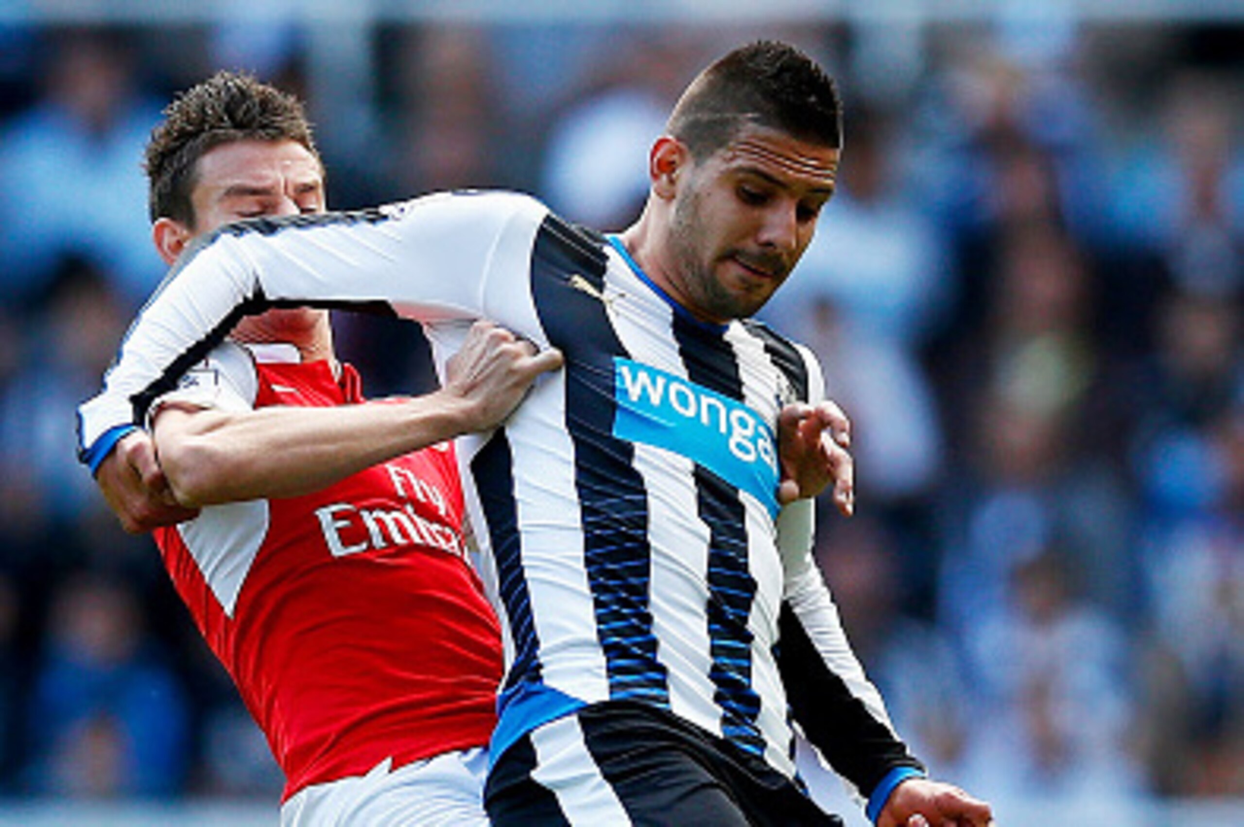 NEWCASTLE UPON TYNE, ENGLAND - AUGUST 29:  Aleksandar Mitrovic of Newcastle United and Laurent Koscielny of Arsenal compete for the ball during the Barclays Premier League match between Newcastle United and Arsenal at St James' Park on August 29, 2015 in 