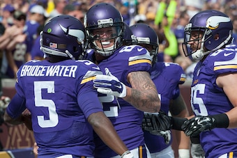 MINNEAPOLIS, MN - SEPTEMBER 20: Teddy Bridgewater #5 of the Minnesota Vikings is congratulated by teammate Kyle Rudolph #82 during an NFL game against the Detroit Lions at TCF Bank Stadium September 20, 2015 in Minneapolis, Minnesota.  (Photo by Tom Dahli
