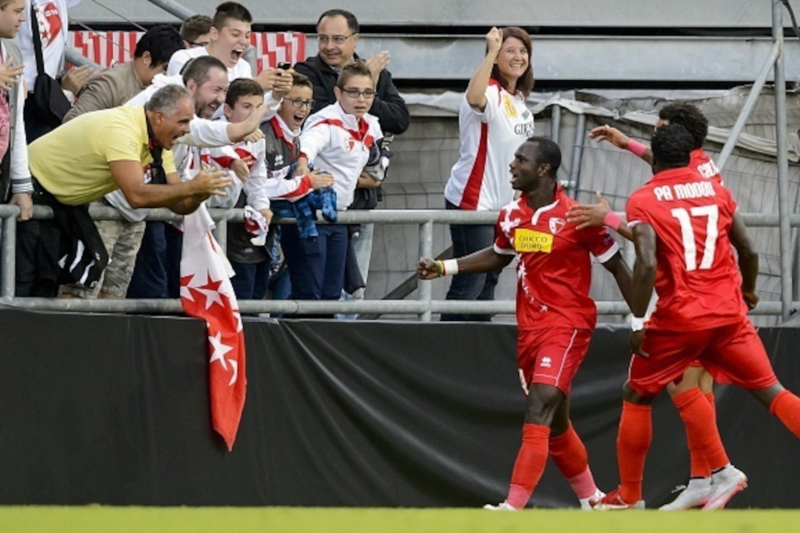 Sion's Senegalese forward Moussa Konate (3rd R) celebrates with teammates and supporters after scoring a goal during the UEFA Europa League group B football match between FC Sion and FC Rubin Kaza on September 17, 2015, at the Tourbillon stadium in Sion. 