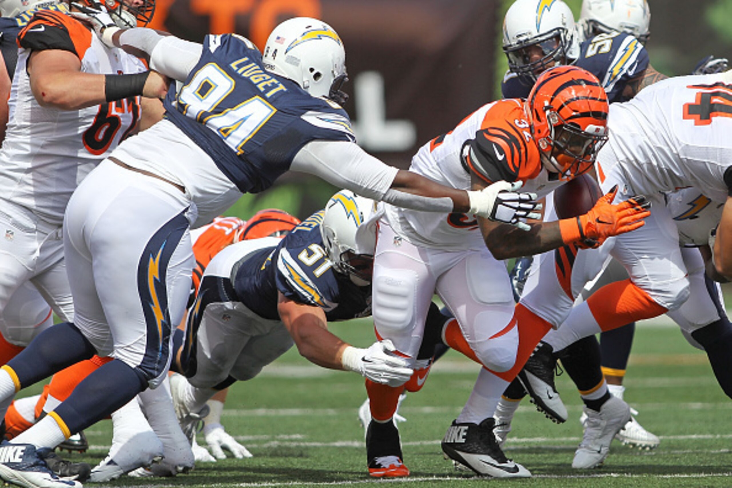 CINCINNATI, OH - SEPTEMBER 20:  Corey Liuget #94 of the San Diego Chargers and Kyle Emanuel #51 of the San Diego Chargers combine to tackle Jeremy Hill #32 of the Cincinnati Bengals during the first quarter at Paul Brown Stadium on September 20, 2015 in C