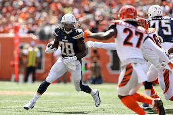 CINCINNATI, OH - SEPTEMBER 20:  Melvin Gordon #28 of the San Diego Chargers attempts to run past Carlos Dunlap #96  and Dre Kirkpatrick #27, both of the Cincinnati Bengals, during the first quarter at Paul Brown Stadium on September 20, 2015 in Cincinnati