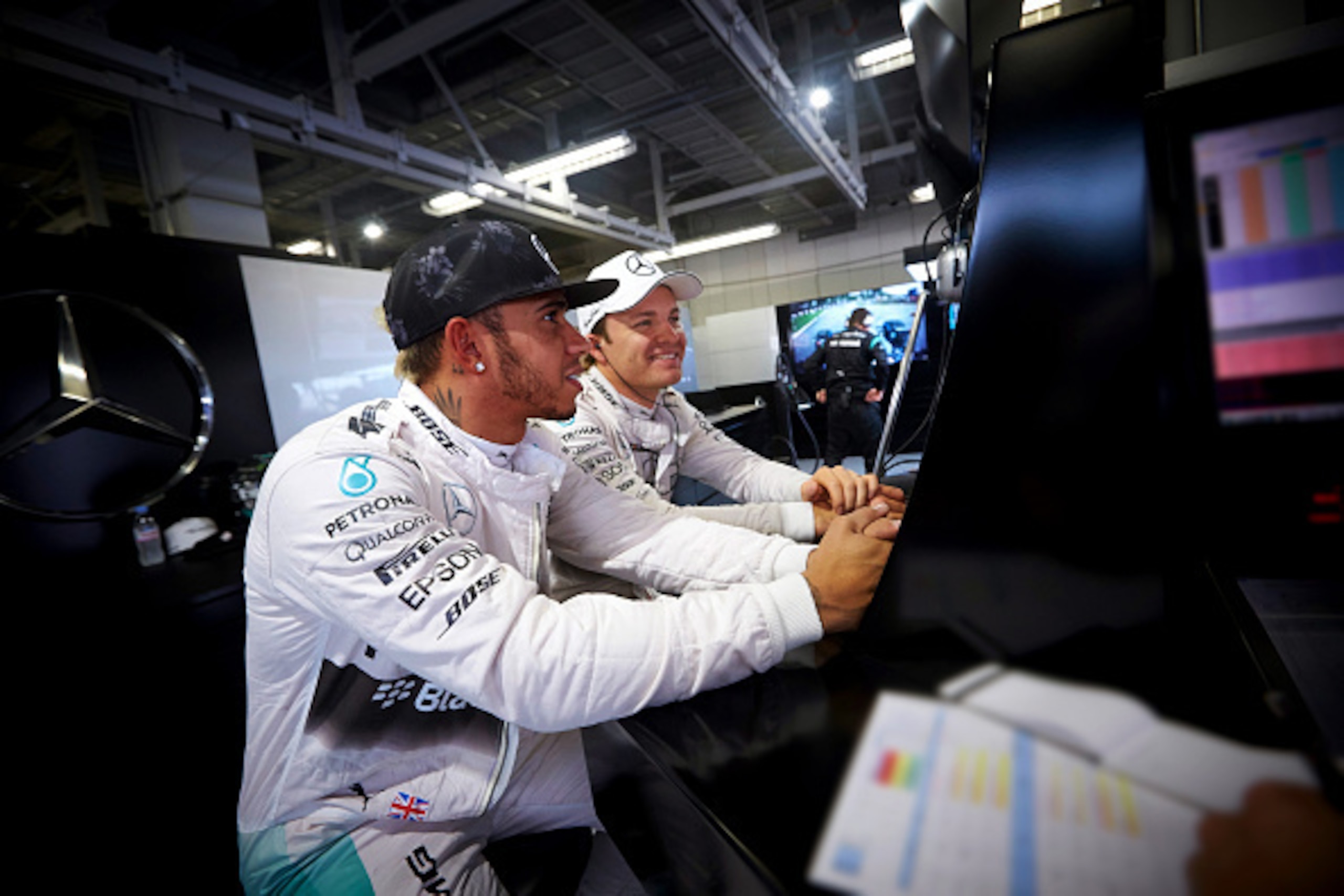 SUZUKA, JAPAN - SEPTEMBER 25:  Lewis Hamilton of Great Britain and Mercedes GP and Nico Rosberg of Germany and Mercedes GP sit together in the garage during practice for the Formula One Grand Prix of Japan at Suzuka Circuit on September 25, 2015 in Suzuka