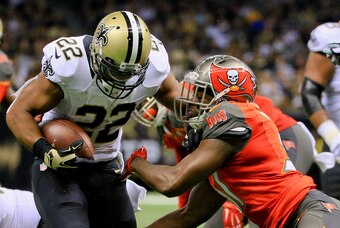 Sep 20, 2015; New Orleans, LA, USA;  New Orleans Saints running back Mark Ingram (22) breaks a tackle by Tampa Bay Buccaneers strong safety Major Wright (31) during the second half of a game at the Mercedes-Benz Superdome. The Buccaneers won 26-19. Mandat