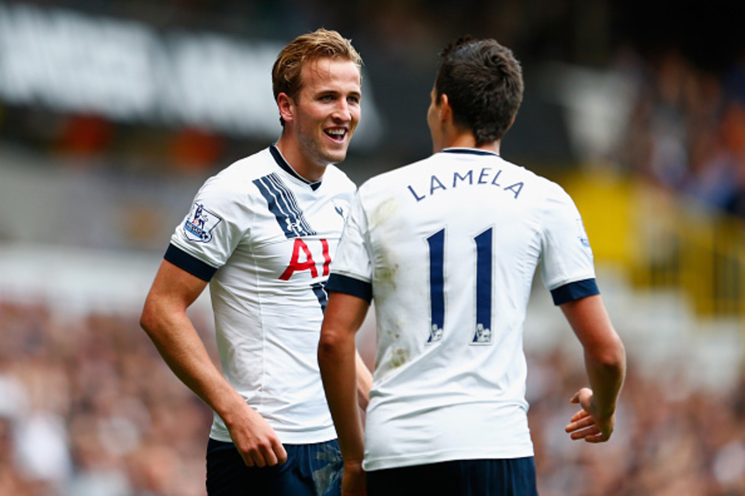 LONDON, ENGLAND - SEPTEMBER 26: Harry Kane (L) of Tottenham Hotspur celebrates scoring his team's third goal with his team mate Erik Lamela (R) during the Barclays Premier League match between Tottenham Hotspur and Manchester City at White Hart Lane on Se