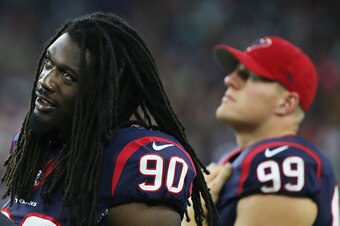 HOUSTON, TX - AUGUST 22:  Jadeveon Clowney #90 and  J.J. Watt #99 of the Houston Texans of the Houston Texans wait on the sidelines in the first half of their game against the Denver Broncos at  NRG Stadium on August 22, 2015 in Houston, Texas.  (Photo by