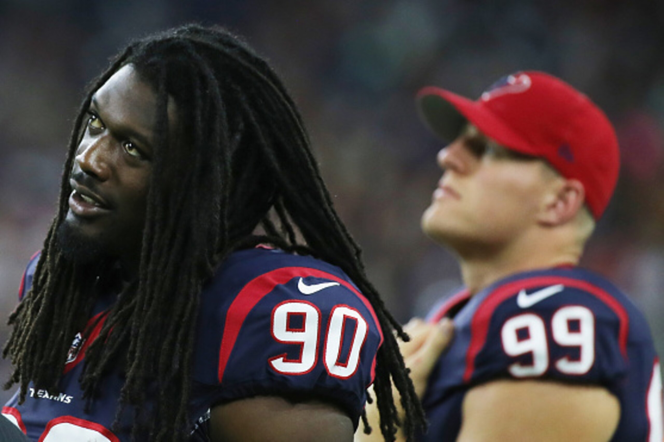 HOUSTON, TX - AUGUST 22:  Jadeveon Clowney #90 and  J.J. Watt #99 of the Houston Texans of the Houston Texans wait on the sidelines in the first half of their game against the Denver Broncos at  NRG Stadium on August 22, 2015 in Houston, Texas.  (Photo by