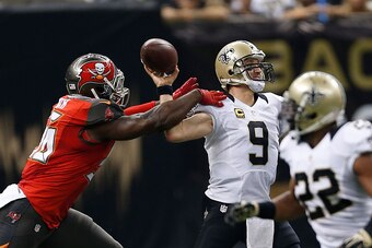 NEW ORLEANS, LA - SEPTEMBER 20:  Drew Brees #9 of the New Orleans Saints is hit by Jacquies Smith #56 of the Tampa Bay Buccaneers during the first quarter of a game at the Mercedes-Benz Superdome on September 20, 2015 in New Orleans, Louisiana.  (Photo by