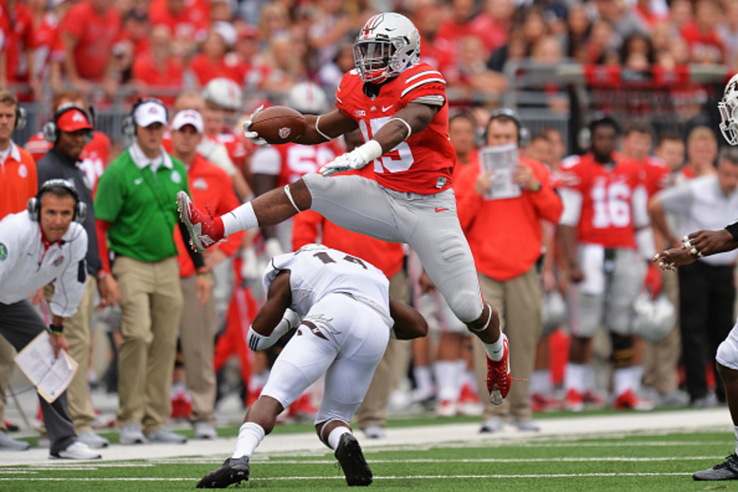 COLUMBUS, OH - SEPTEMBER 26:  Ezekiel Elliott #15 of the Ohio State Buckeyes leaps over Darius Phillips #14 of the Western Michigan Broncos for a first down gain in the second quarter at Ohio Stadium on September 26, 2015 in Columbus, Ohio.  (Photo by Jam