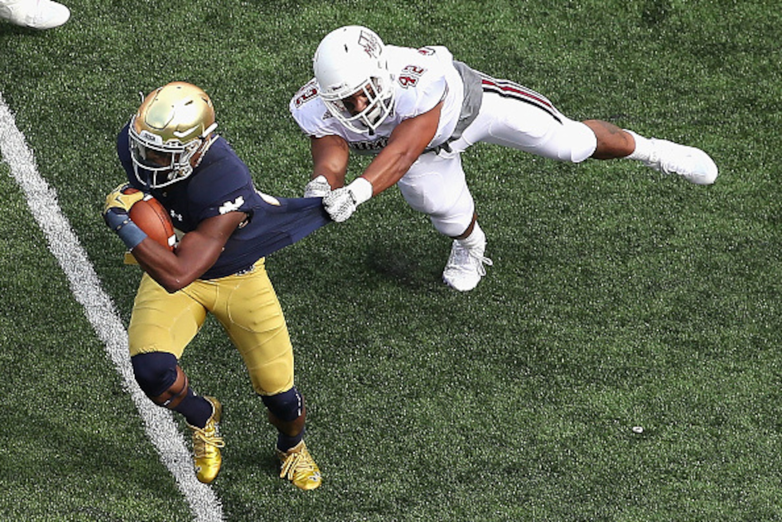 SOUTH BEND, IN - SEPTEMBER 26: C.J. Prosise #20 of the Notre Dame Fighting Irish breaks away from John Robinson-Woodgett #42 of the Massachusetts Minutemen at Notre Dame Stadium on September 26, 2015 in South Bend, Indiana. (Photo by Jonathan Daniel/Getty