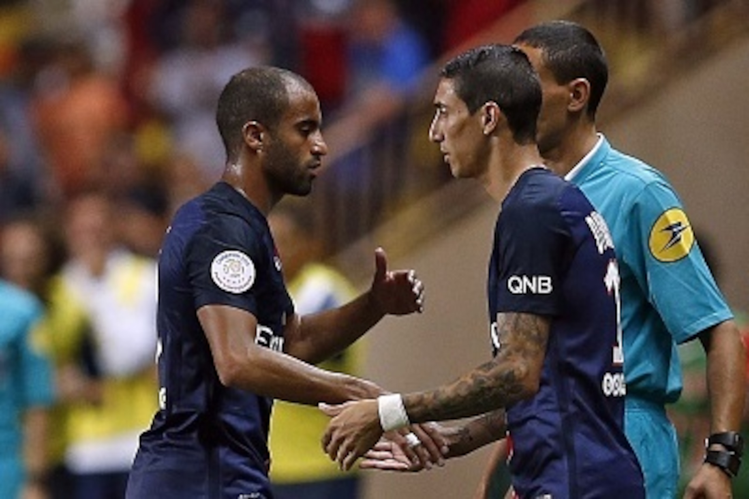 Paris Saint-Germain's Brazilian midfielder Lucas Moura (L) is substituted by Paris Saint-Germain's Argentinian forward Angel Di Maria (R) during the French L1 football match Monaco (ASM) vs Paris Saint-Germain (PSG), on August 30, 2015 at the Louis II sta