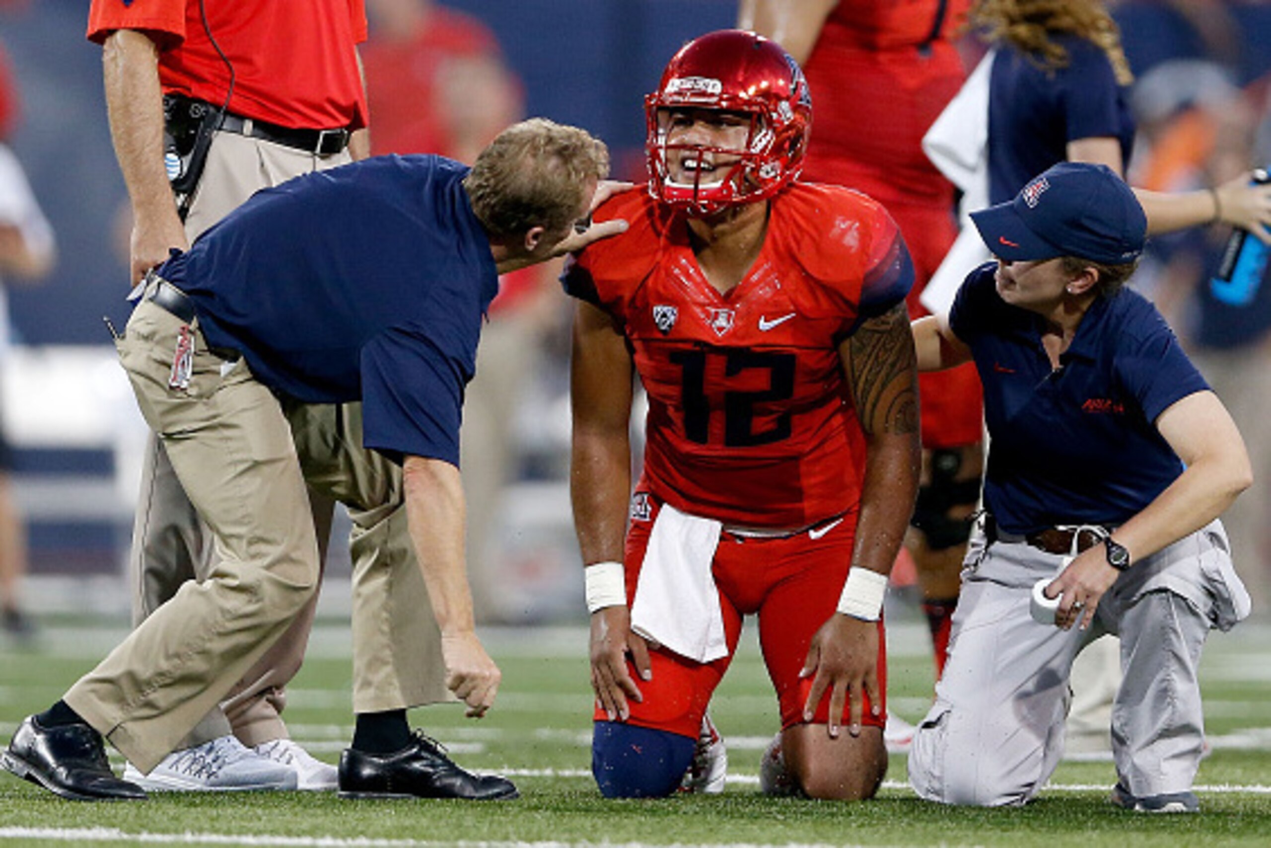 TUCSON, AZ - SEPTEMBER 26:  Quarterback Anu Solomon #12 of the Arizona Wildcats reacts after an injury during the second quarter of the college football game against the UCLA Bruins at Arizona Stadium on September 26, 2015 in Tucson, Arizona.  (Photo by C
