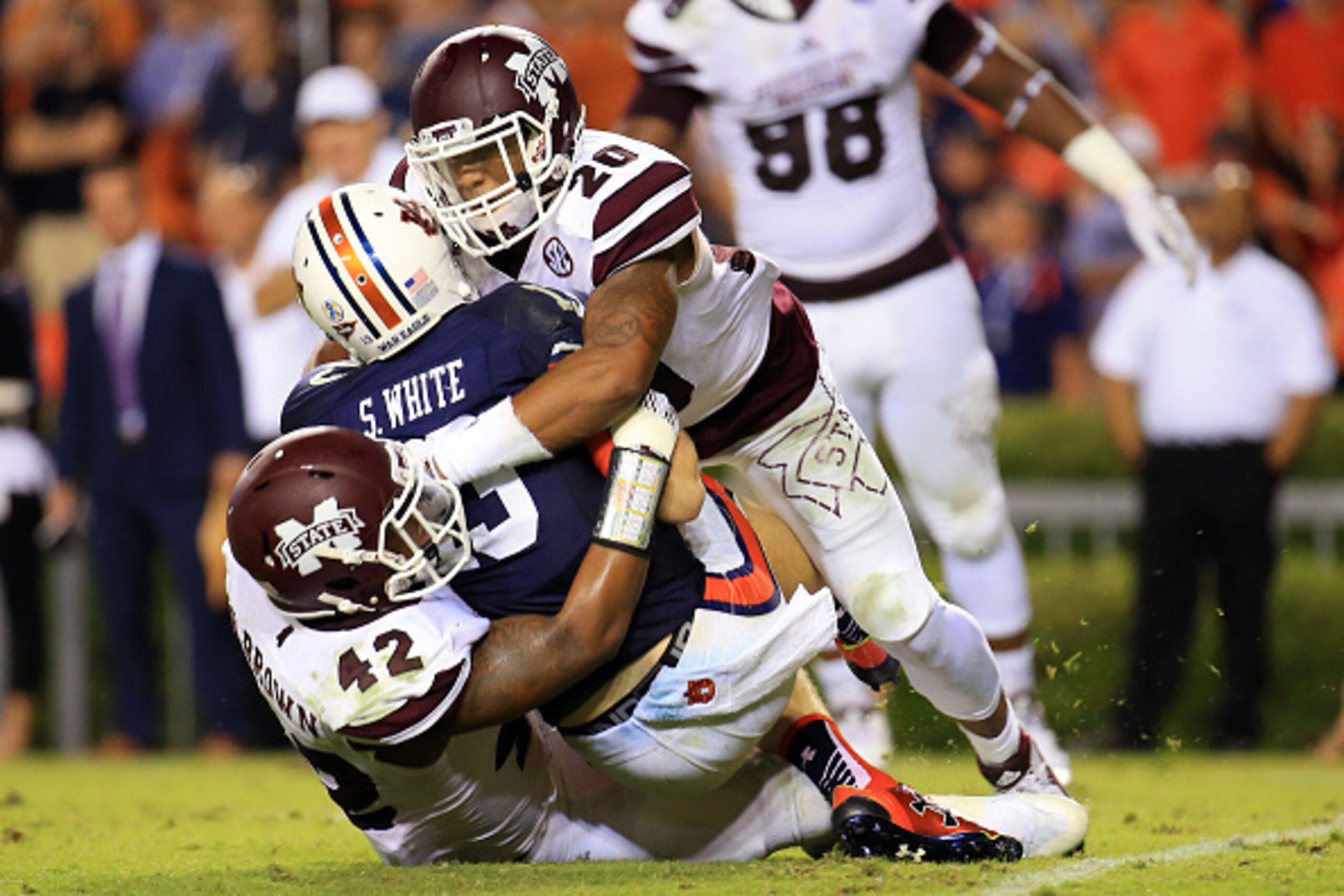 AUBURN, AL - SEPTEMBER 26:  Beniquez Brown #42 and Brandon Bryant #20 of the Mississippi State Bulldogs sack Sean White #13 of the Auburn Tigers during the second at Jordan Hare Stadium on September 26, 2015 in Auburn, Alabama.  (Photo by Daniel Shirey/Ge