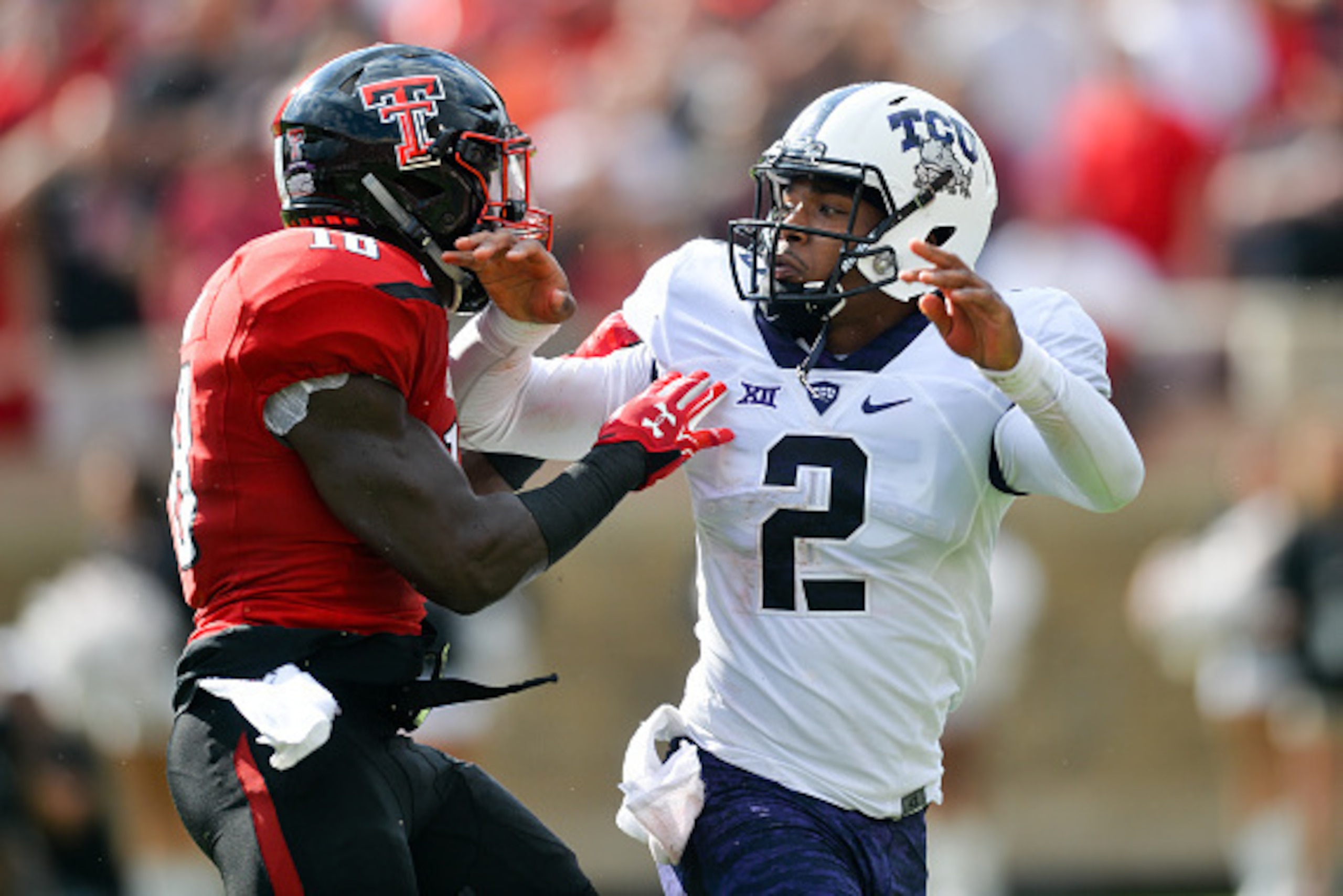 LUBBOCK, TX - SEPTEMBER 26: Trevone Boykin #2 of the TCU Horned Frogs is pressured by Micah Awe #18 of the Texas Tech Red Raiders on September 26, 2015 at Jones AT&T Stadium in Lubbock, Texas. TCU won the game 55-52. Photo by John Weast/Getty Images)