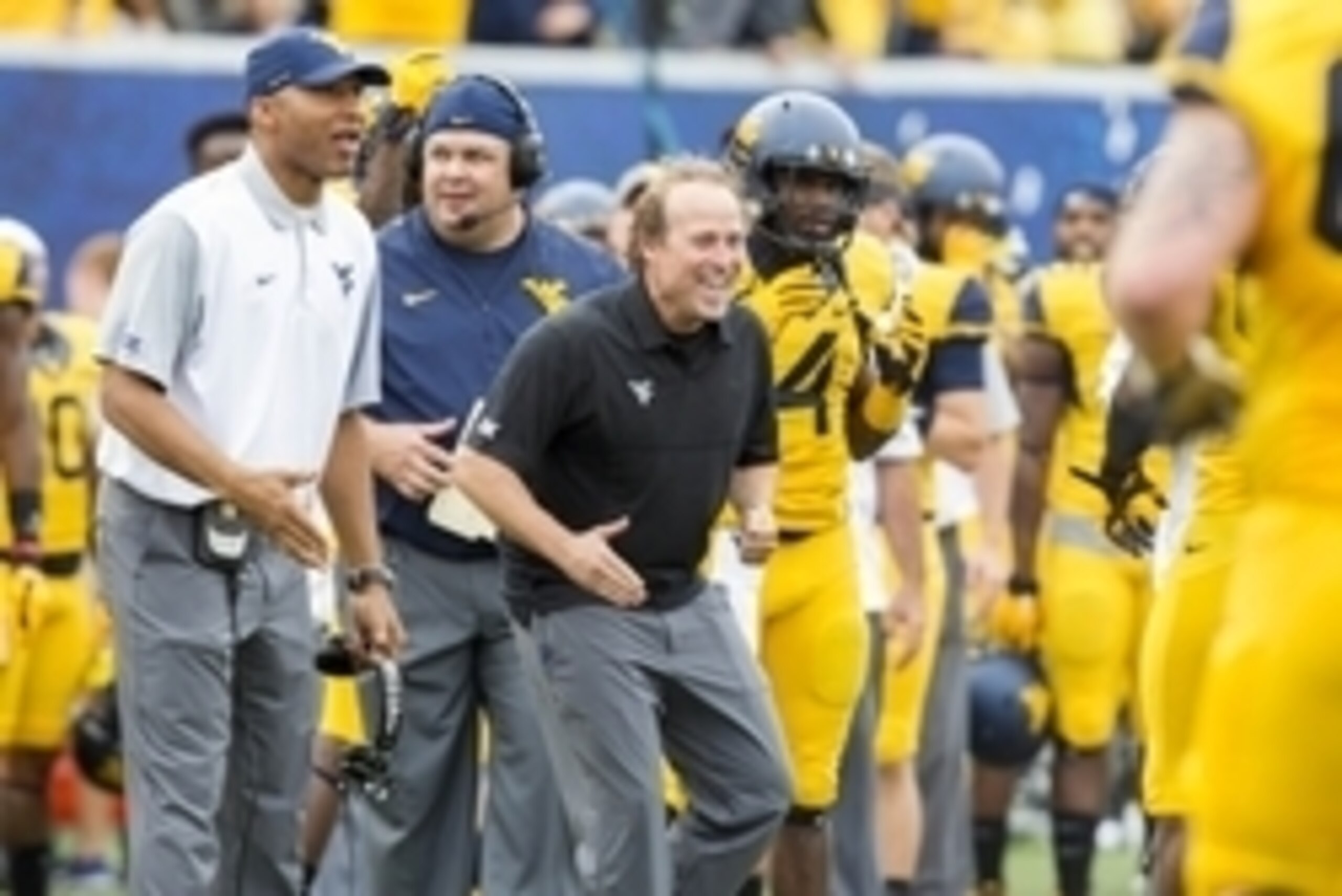 Sep 26, 2015; Morgantown, WV, USA; West Virginia Mountaineers head coach Dana Holgorsen celebrates with his players after scoring a touchdown against the Maryland Terrapins during the second quarter at Milan Puskar Stadium. Mandatory Credit: Ben Queen-USA