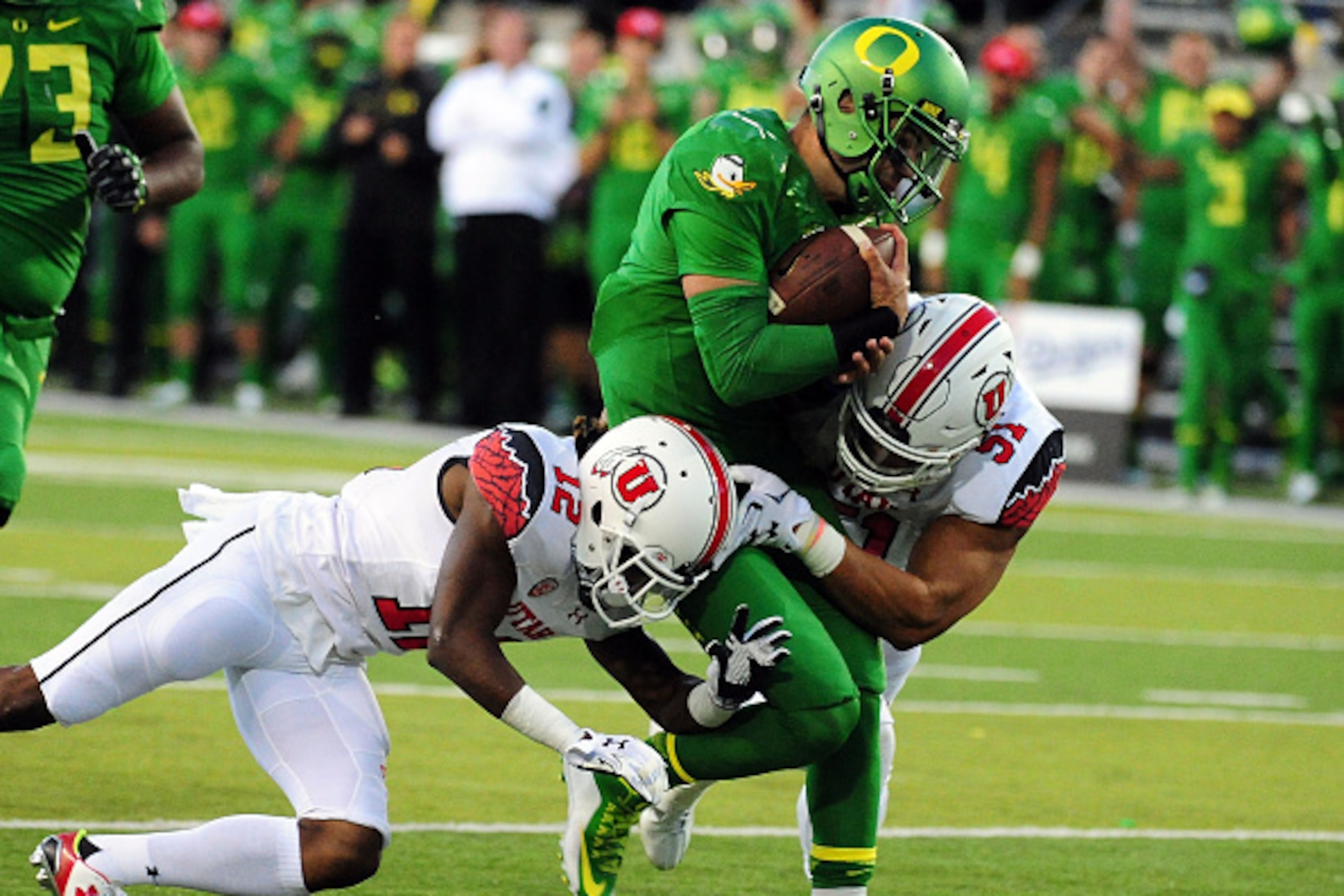 EUGENE, OR - SEPTEMBER 26: Quarterback Jeff Lockie #17 of the Oregon Ducks is tackled by defensive back Justin Thomas #12 and defensive end Jason Fanaika #51 of the Utah Utes in the second quarter of the game at Autzen Stadium on September 26, 2015 in Eug