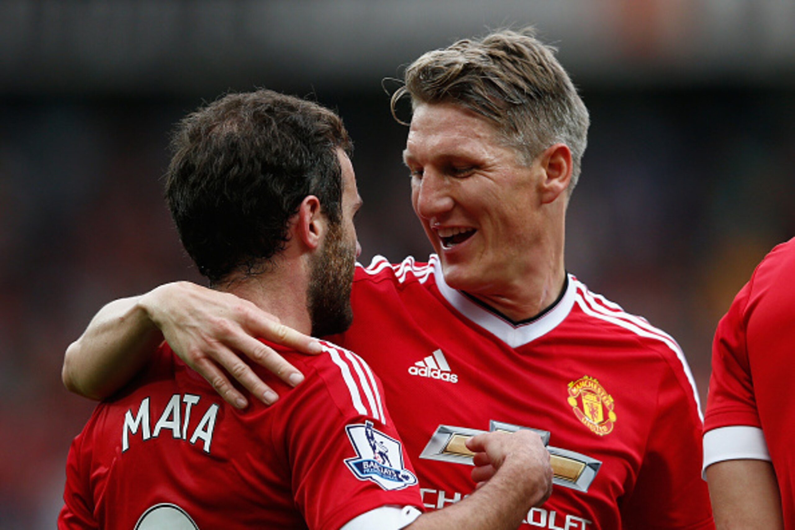 MANCHESTER, ENGLAND - SEPTEMBER 26:  Juan Mata (L) of Manchester United celebrates scoring his team's third goal with his team mate Bastian Schweinsteiger (R) during the Barclays Premier League match between Manchester United and Sunderland at Old Traffor