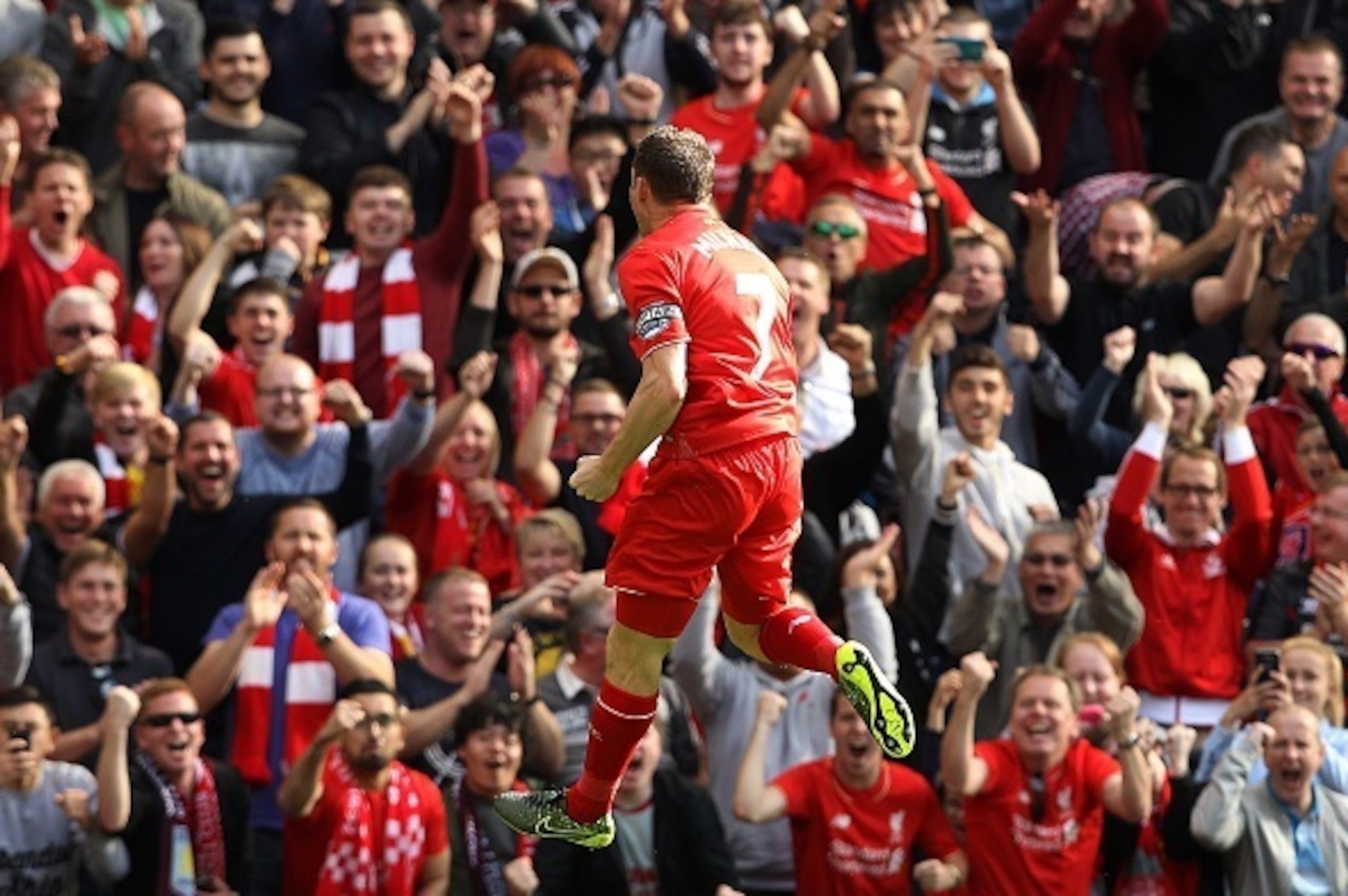 Liverpool's English midfielder James Milner celebrates after scoring his team's first goal  during the English Premier League football match between Liverpool and Aston Villa at the Anfield stadium in Liverpool, north-west England, on September 26, 2015. 