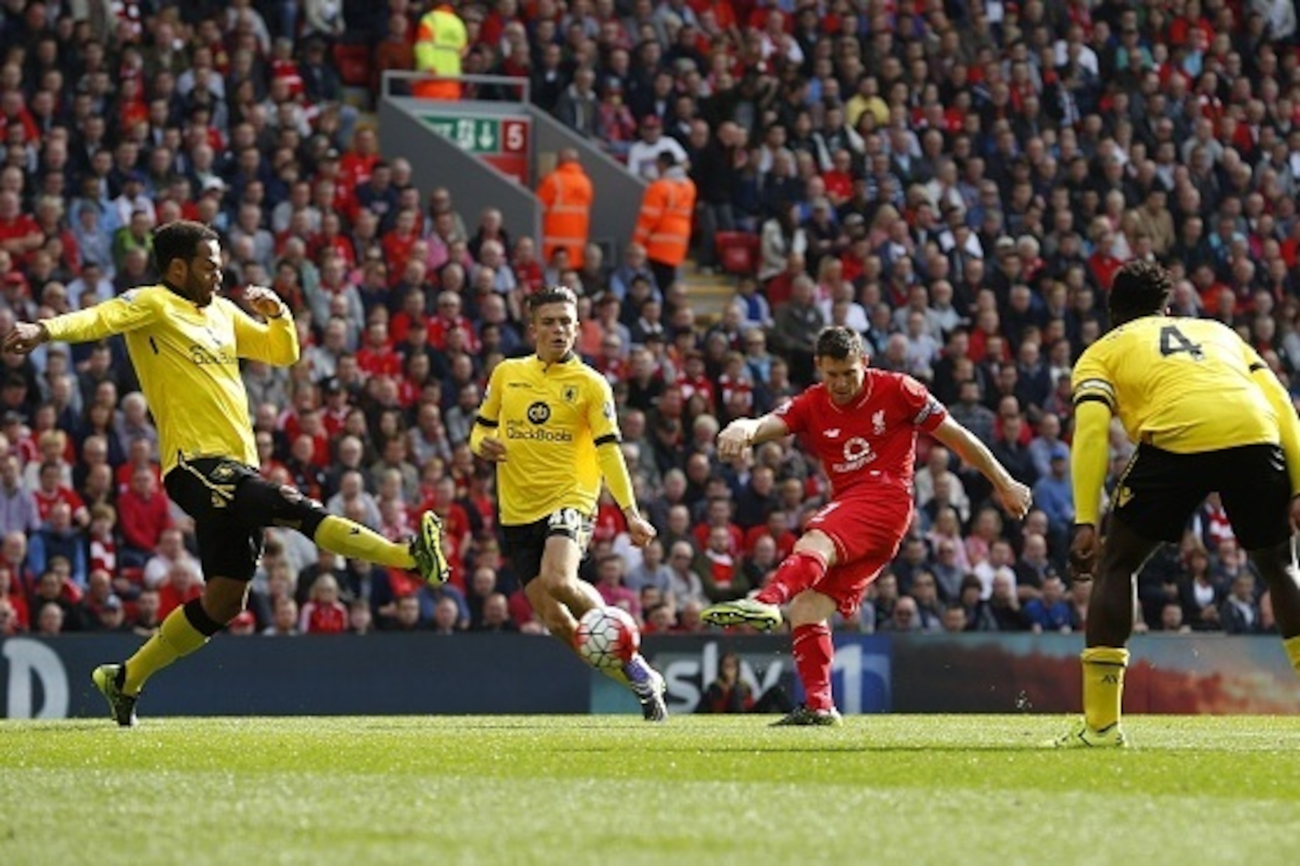 Liverpool's English midfielder James Milner (2nd R) scores his team's first goal  during the English Premier League football match between Liverpool and Aston Villa at the Anfield stadium in Liverpool, north-west England, on September 26, 2015. AFP PHOTO 
