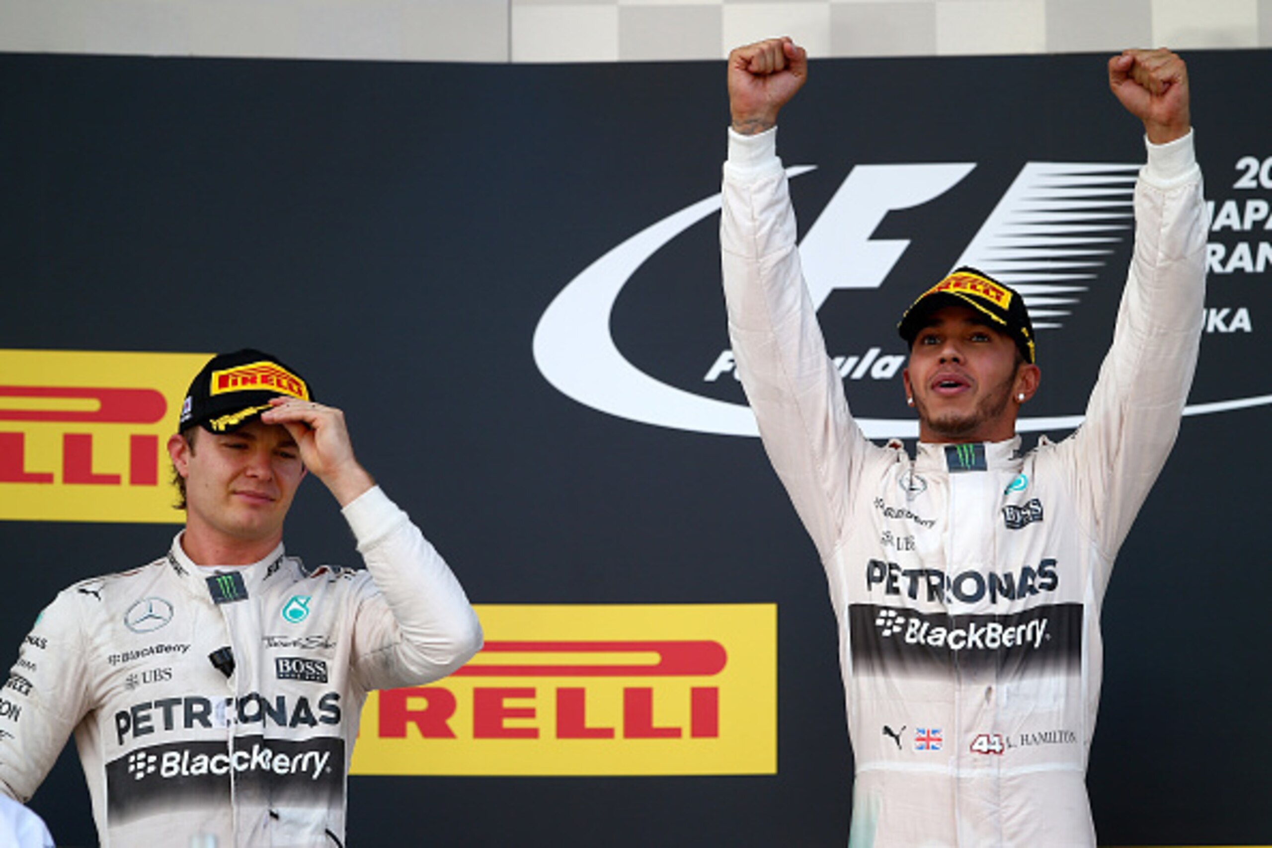SUZUKA, JAPAN - SEPTEMBER 27: Lewis Hamilton of Great Britain and Mercedes GP celebrates next to Nico Rosberg of Germany and Mercedes GP on the podium after winning the Formula One Grand Prix of Japan at Suzuka Circuit on September 27, 2015 in Suzuka, Ja SUZUKA, JAPAN - SEPTEMBER 27: Lewis Hamilton of Great Britain and Mercedes GP celebrates next to Nico Rosberg of Germany and Mercedes GP on the podium after winning the Formula One Grand Prix of Japan at Suzuka Circuit on September 27, 2015 in Suzuka, Ja