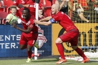 Sep 26, 2015; Toronto, Ontario, CAN; Toronto FC midfielder Michael Bradley (4) reacts to the winning goal against the Chicago Fire by Toronto FC forward Jozy Altidore (left) at BMO Field. Toronto defeated Chicago 3-2. Mandatory Credit: John E. Sokolowski-