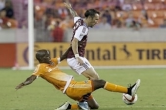 Sep 26, 2015; Houston, TX, USA; iHouston Dynamo defender/midfielder DaMarcus Beasley (7) tackles Colorado Rapids forward Vicente Sanchez (7) in the second half at BBVA Compass Stadium. Dynamo won 3 to 2. Mandatory Credit: Thomas B. Shea-USA TODAY Sports