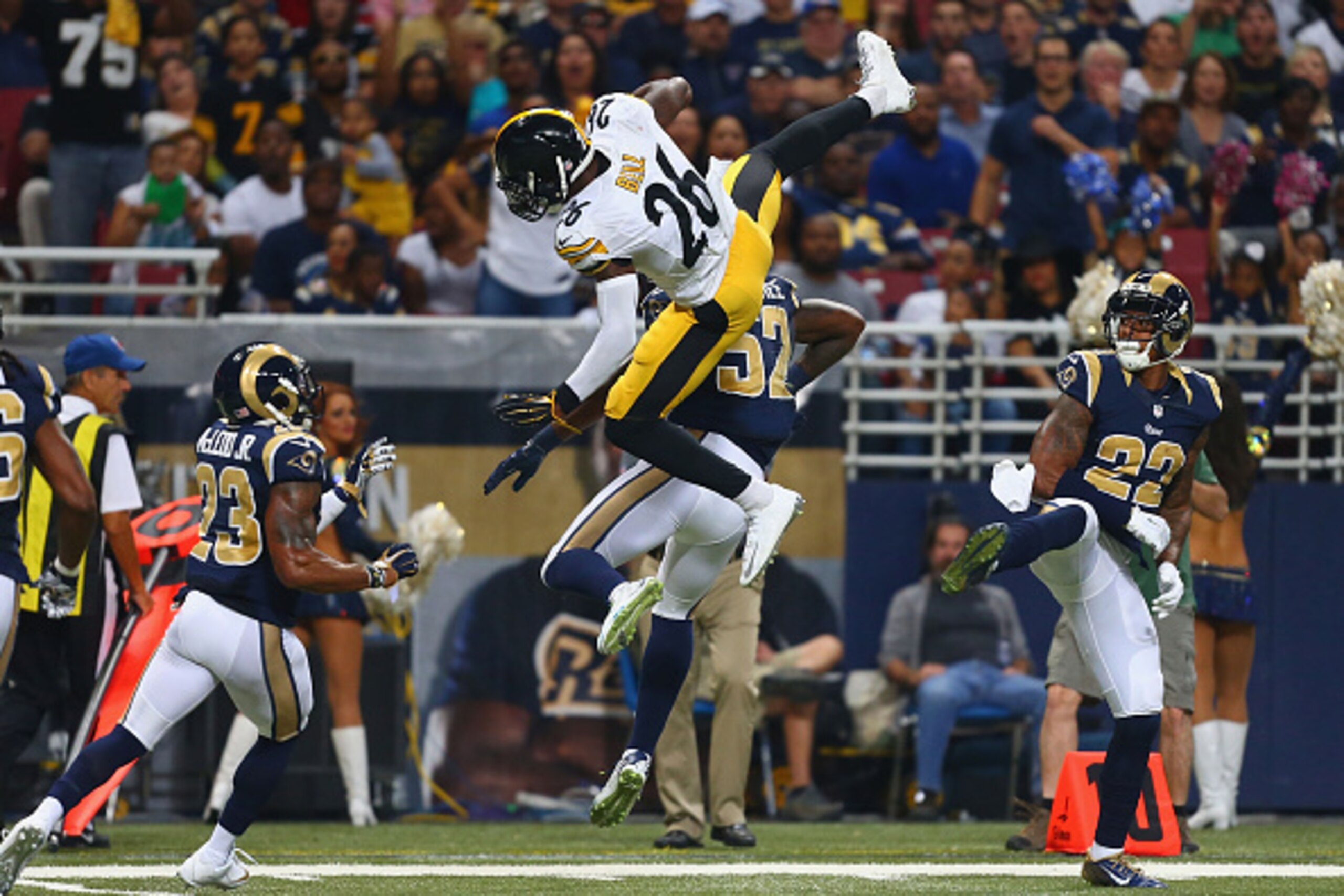 ST. LOUIS, MO - SEPTEMBER 27: Le'Veon Bell #26 of the Pittsburgh Steelers is tackled by Alec Ogletree #52 of the St. Louis Rams in the second quarter at the Edward Jones Dome on September 27, 2015 in St. Louis, Missouri.  (Photo by Dilip Vishwanat/Getty I