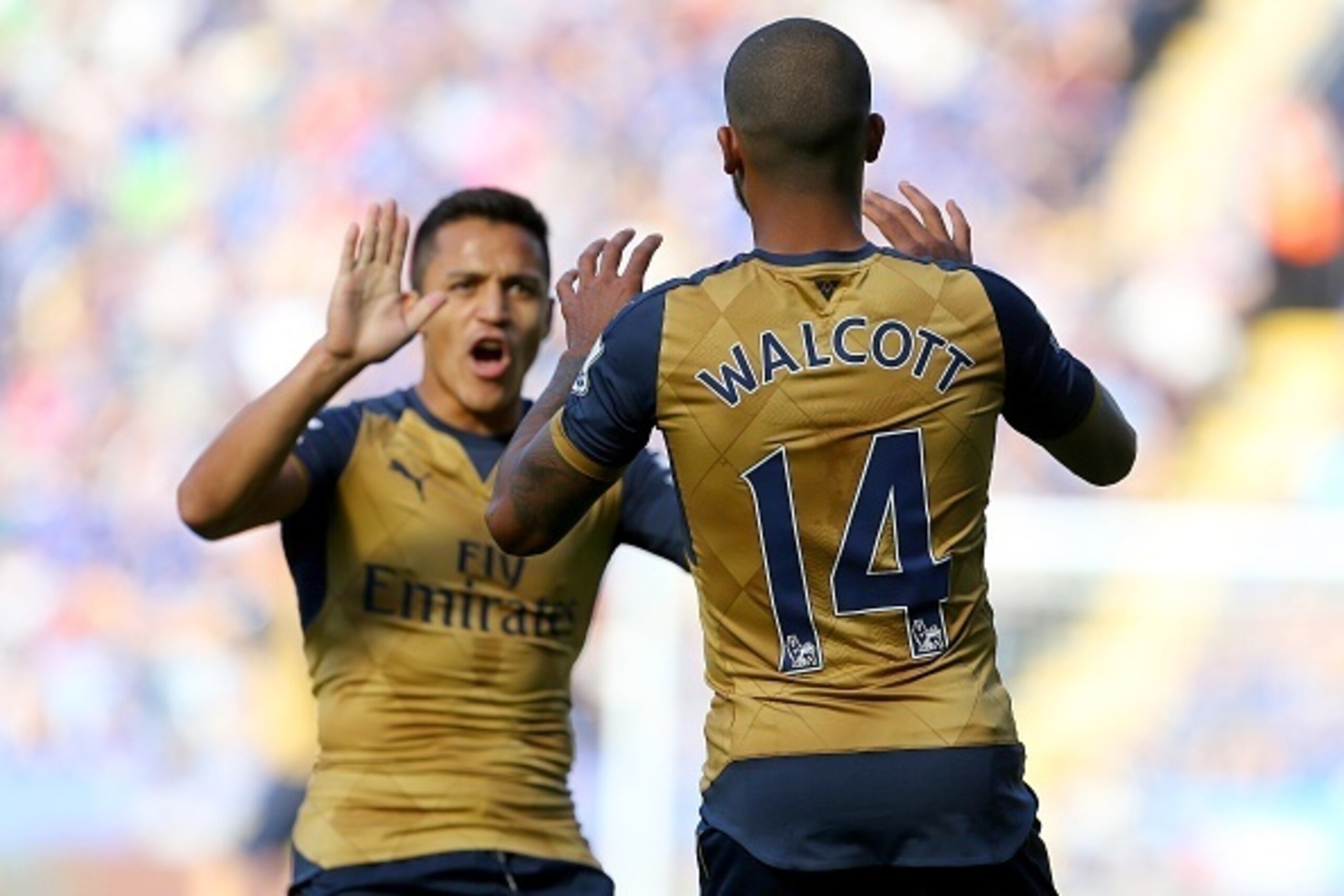 Arsenals English striker Theo Walcott (R) celebrates with Arsenal's Chilean striker Alexis Sanchez after Walcott socred his team's opening goal during the English Premier League football match between Leicester City and Arsenal at King Power Stadium in Le