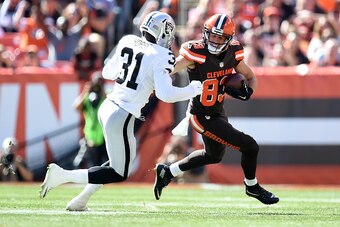 CLEVELAND, OH - SEPTEMBER 27:  Brian Hartline #83 of the Cleveland Browns gets past the defense of Neiko Thorpe #31 of the Oakland Raiders for a first down during the first quarter at FirstEnergy Stadium on September 27, 2015 in Cleveland, Ohio.  (Photo b